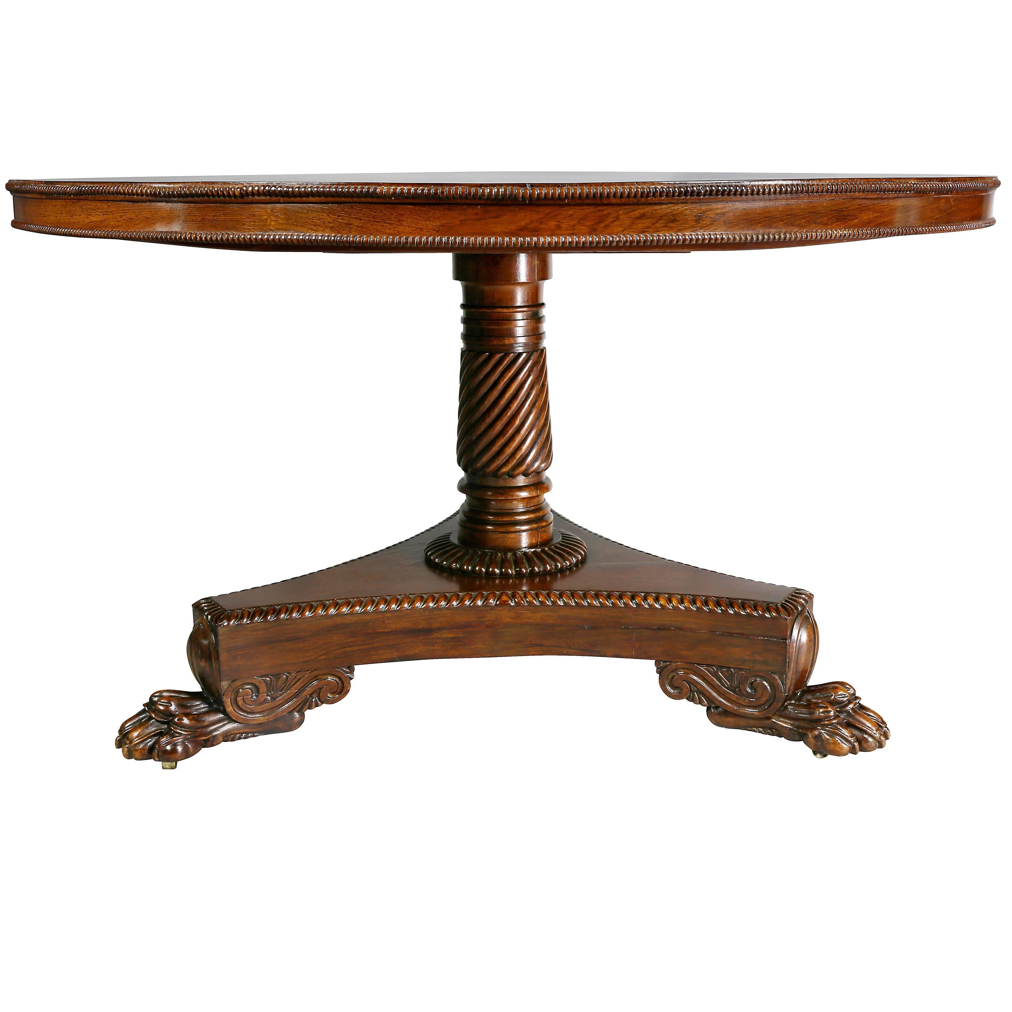 Circular tilt top with conforming beaded apron, spiral reeded support raised on a tripartite base with vitruvian scroll and claw feet.