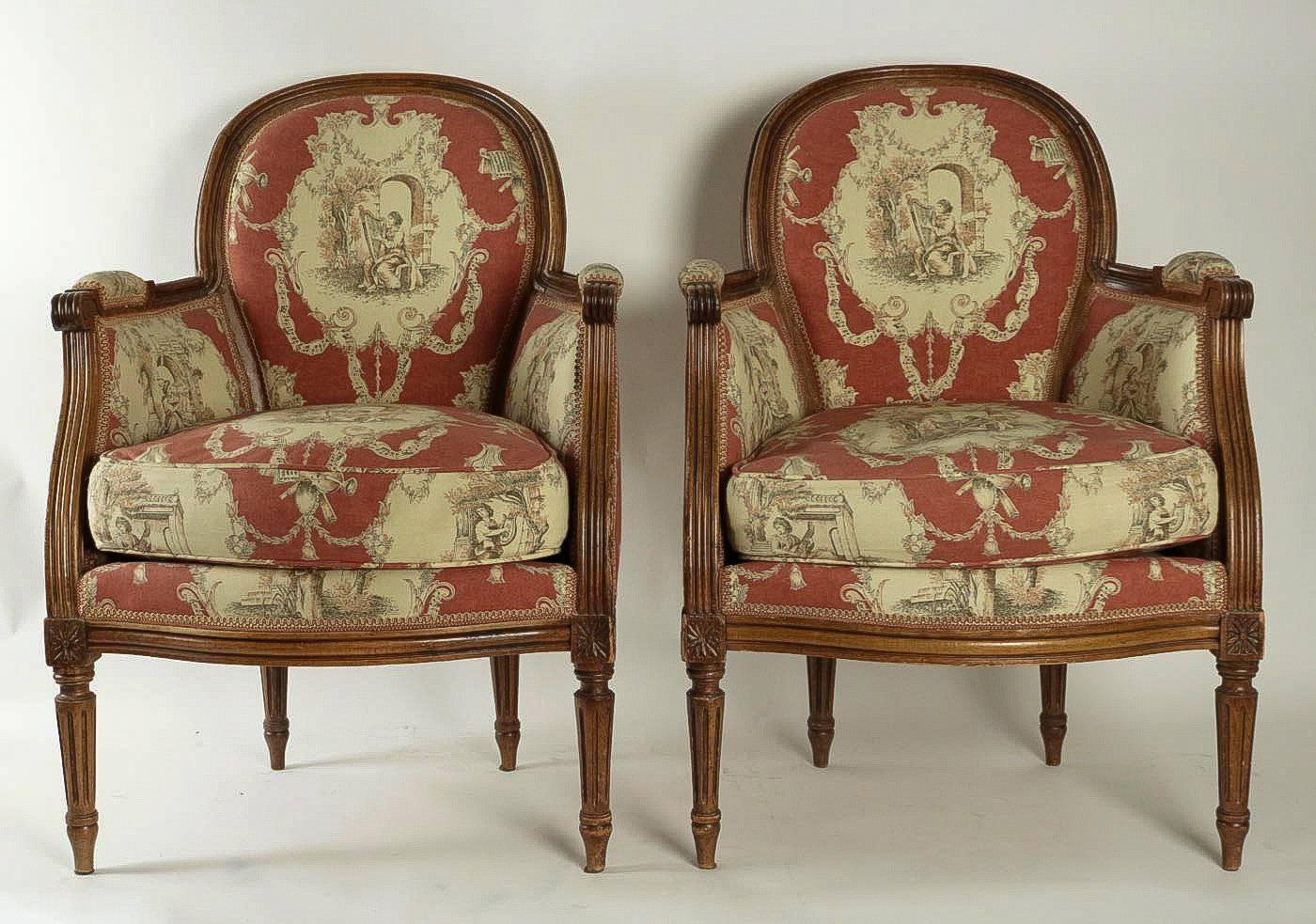 We are pleased to present you a gorgeous hand-carved Louis XVI style fruitwood pair of Bergeres.

French work 19th century.

Fine condition. These beautiful Bergeres are very solid, and there has been upholstered with a new red Jouy