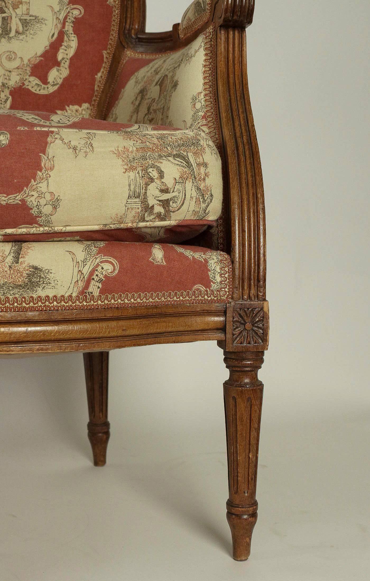 Hand-Carved Pair of French 19th Century, Louis XVI Style Fruitwood Bergeres For Sale