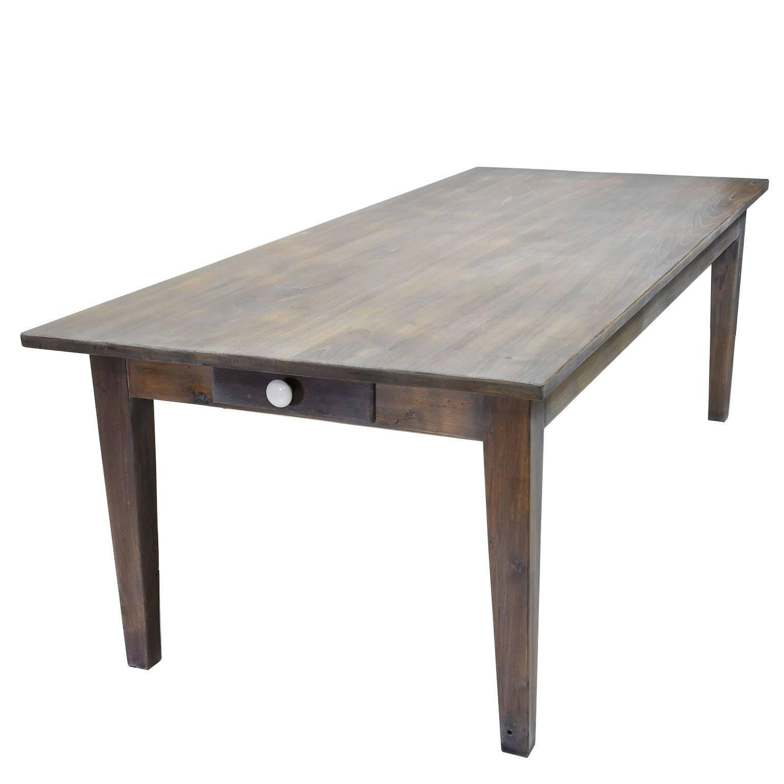 A one-of-a-kind, custom made rectangular dining table with square tapering legs in repurposed white French oak, with pull-out server on one end of the table and a drawer on the other. Table is finished with a LEED-certified organic oil in a