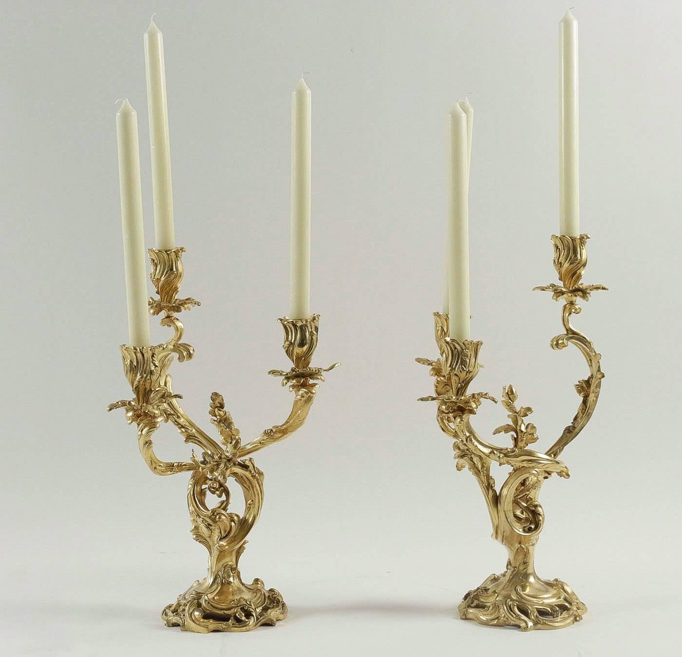 An exciting and elegant pair of candelabras, with three candlesticks arm-lights, in the classic Louis XV Rocaille style.
Original gilt bronze candelabras, finely chiseled of foliage, oak leaves, and acorn decoration.
Our candelabras rest on lovely