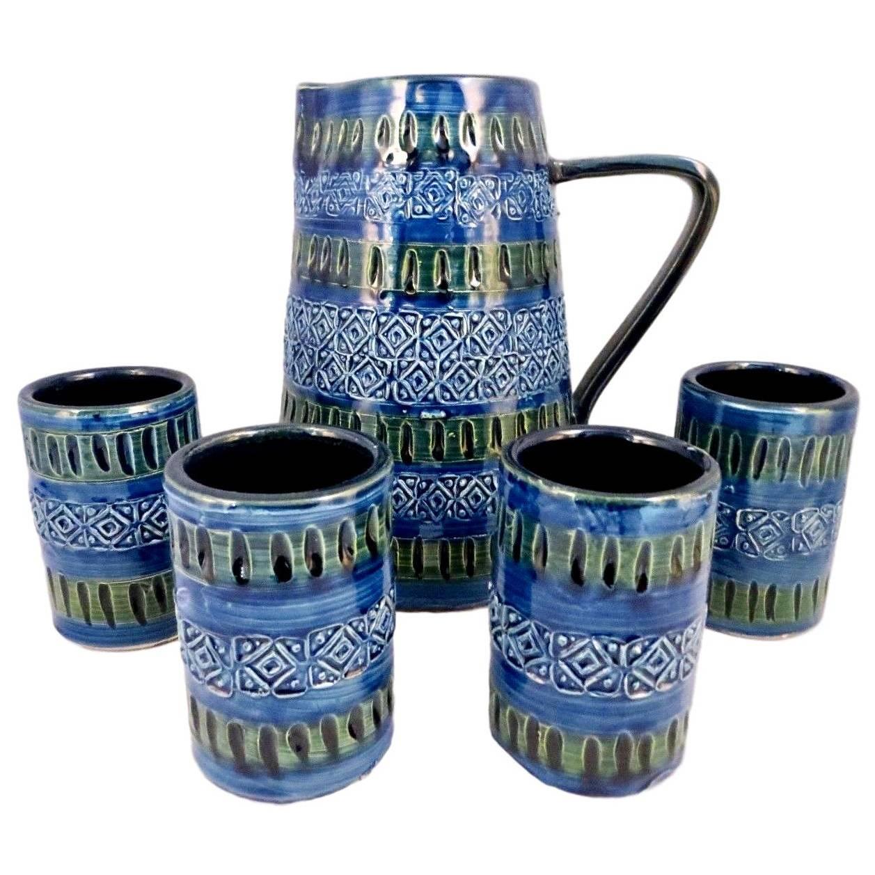 Stunning Italian drinking set by Bitossi. Pitcher and four cups. Marked Italy on underside. Excellent condition. Gorgeous blues and greens. Artwork for your tabletop.

Measures: Pitcher 8 H x 7.5 D

Tumblers 3.75 H x 2.5 D