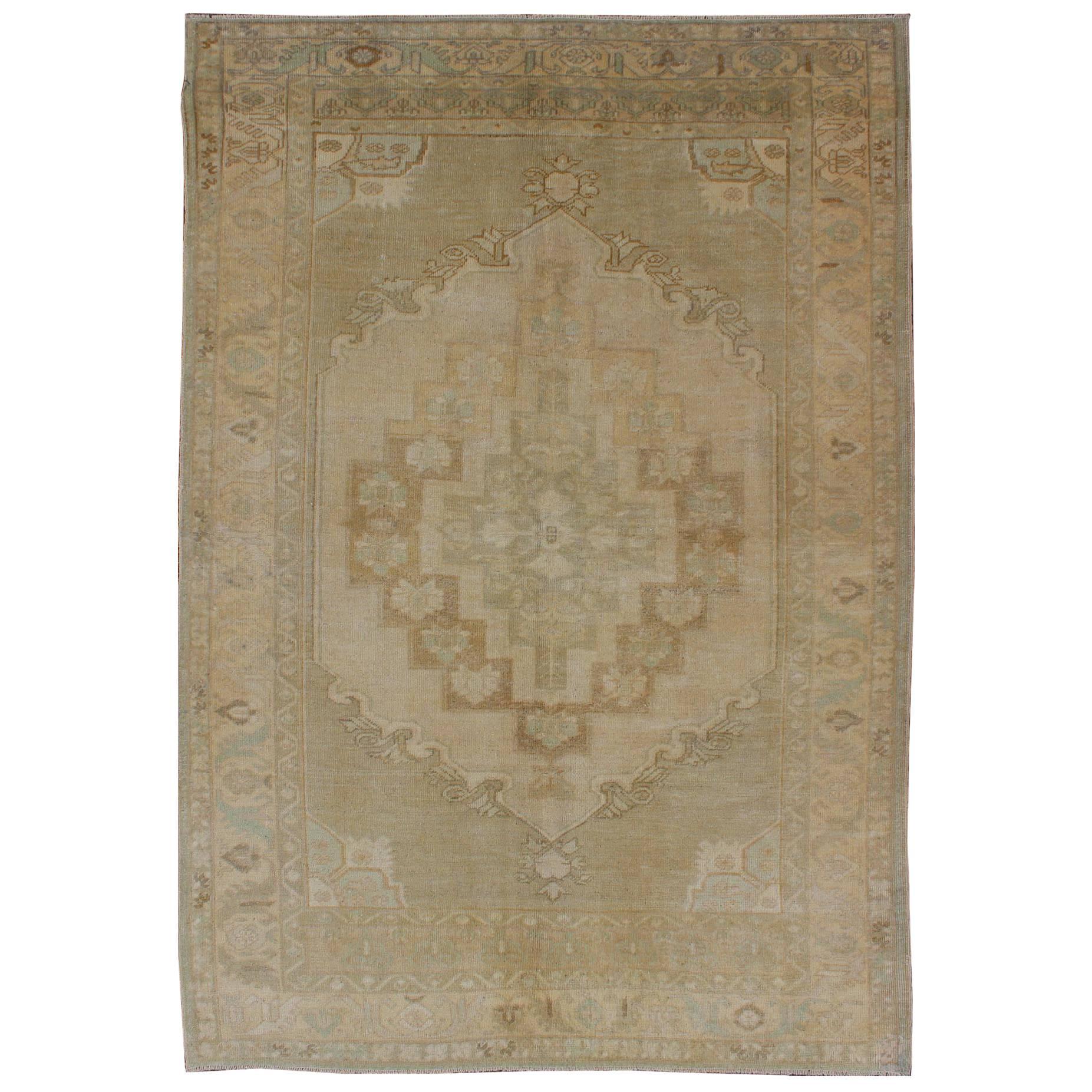 Faded Vintage Turkish Oushak Rug with Layered Medallion in Creams and Grays For Sale