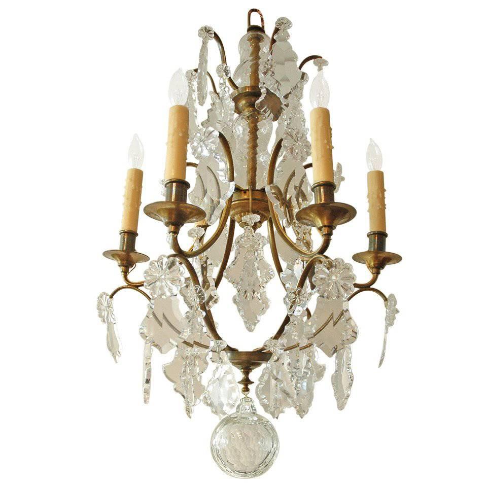 Late 19th century interpretation of Swedish Rococo. Crystals prisms were designed to refract light. Originally it was candle light that was being refracted but it works just as well with the soft light from 15 watt incandescent bulbs.

Measures: 18