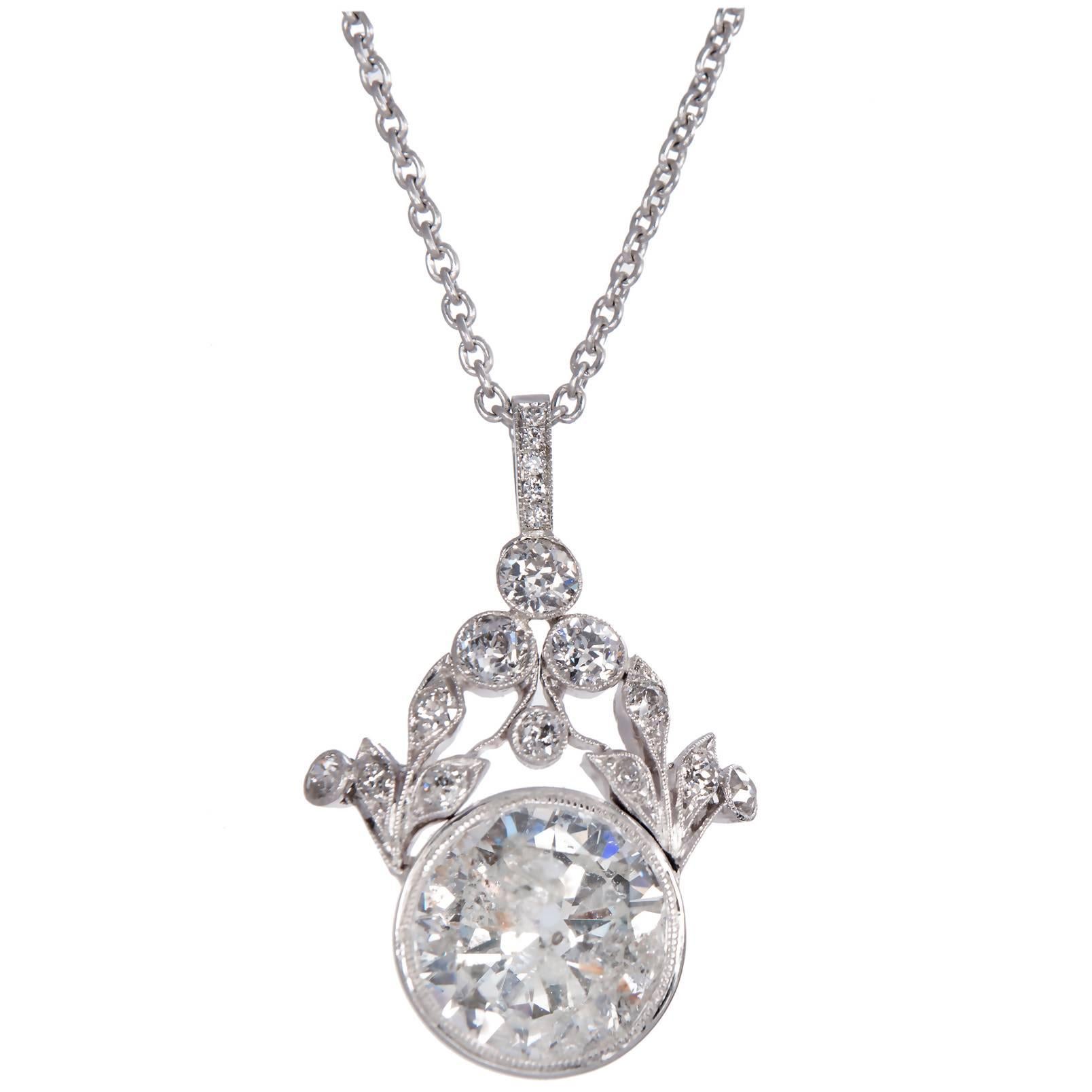 1940s faint grey transitional cut diamond that faces up with a hint of natural color and a few eye visible flaws that are part of the one of a kind character of the pendant. The top is handmade with old European cut diamonds. The pendant and chain