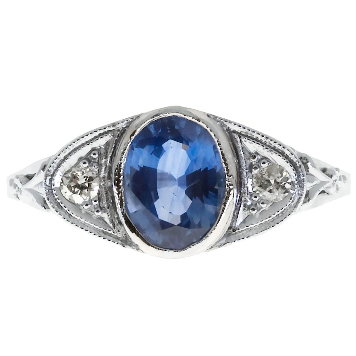  Oval Sapphire Diamond Hand Pierced Engraved Filigree Gold engagement Ring. Flat top is set in the center with a vibrant bright blue genuine sapphire. On either side is a fine white old European cut diamond. Circa 1940-1949.

1 round sapphire