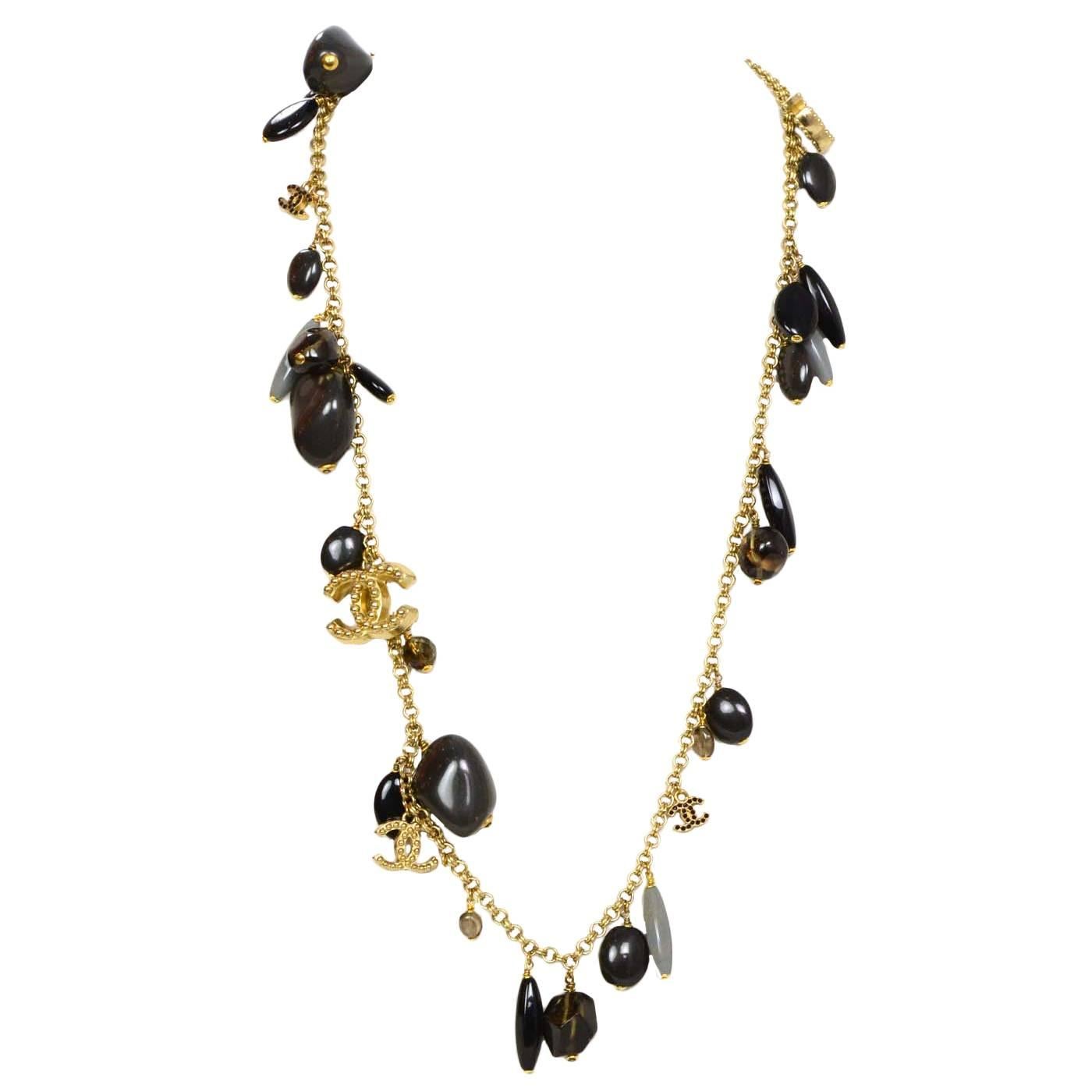 Chanel Grey & Brown Stone Pendant Long Necklace 

Features goldtone CC's throughout with black crystals
Color: Goldtone, black, brown, and grey
Materials: Metal, stone, and crystal
Closure: Lobster claw closure
Overall Condition: Excellent pre-owned