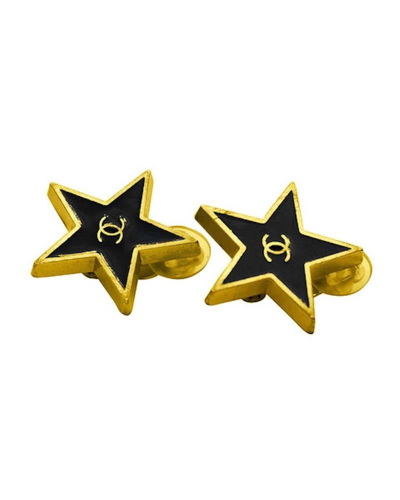 Vintage Chanel earrings circa 1990 with a gold-tone outline and CC logo on a black background. Classic Chanel markings on the backs, as well as plastic earlobe protectors. In excellent condition. 