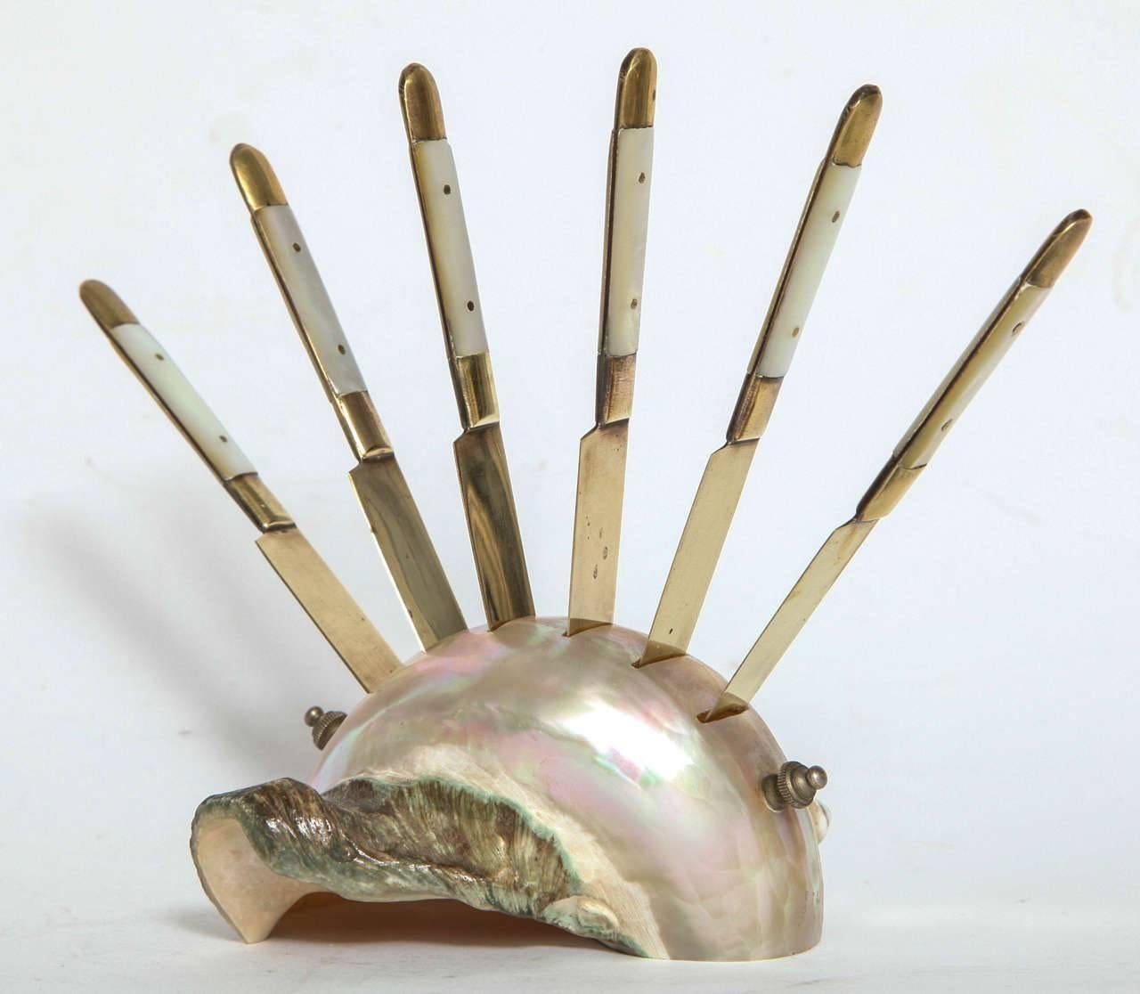 A charming mother-of-pearl and bronze pate knife set on a shell stand.
A conversation piece for a dinner party.