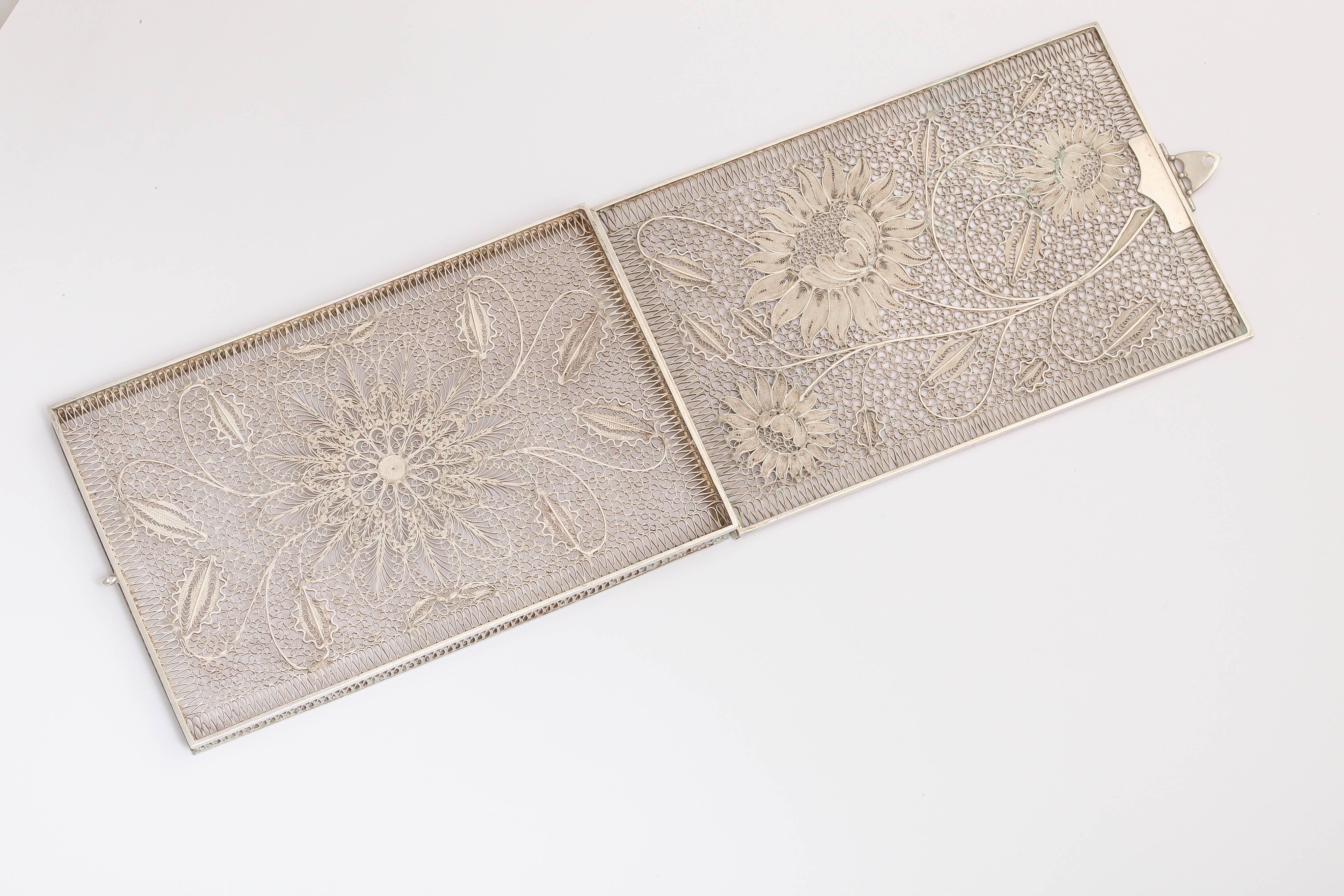 A delicate floral sterling silver card case with clasp.