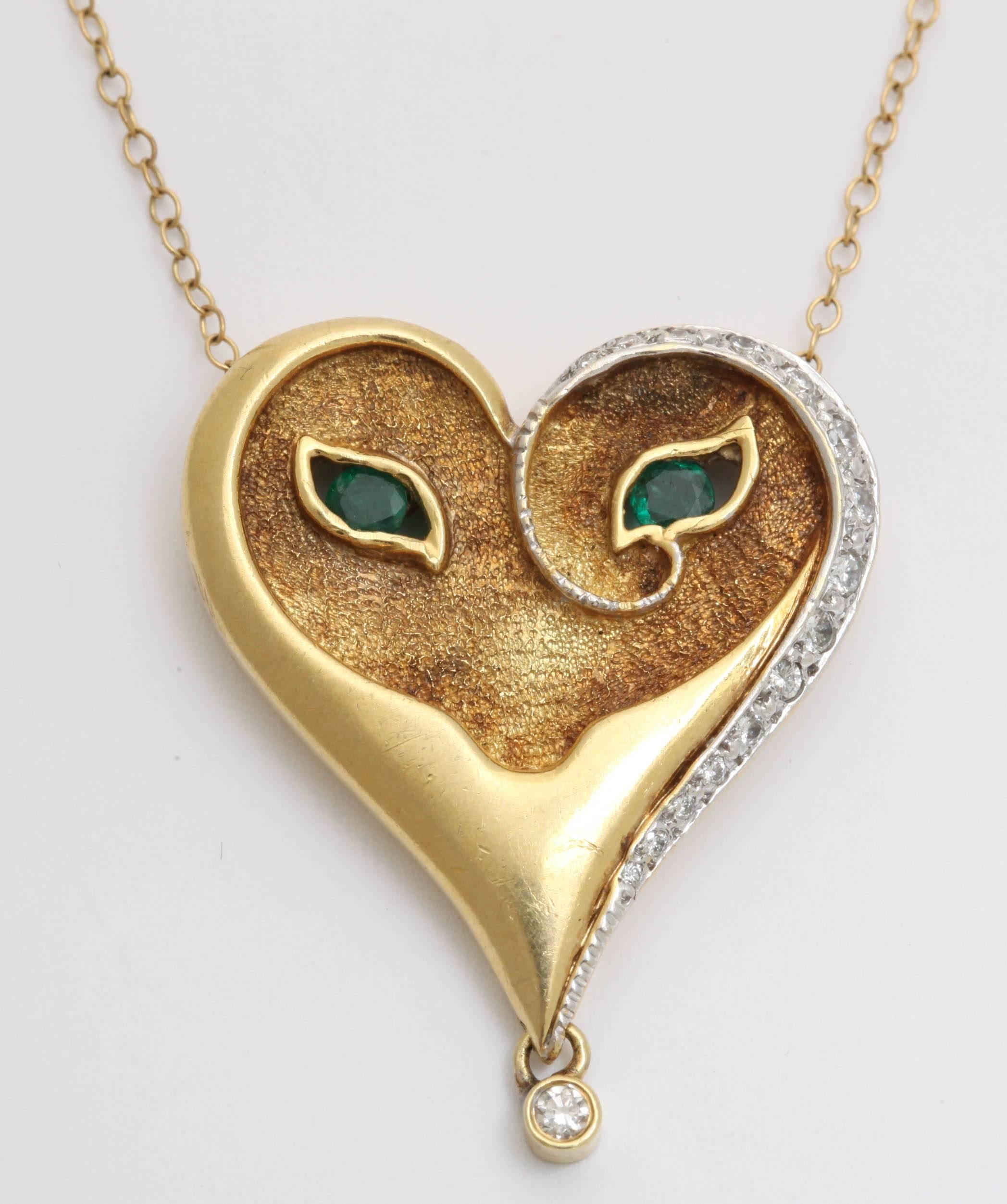 A wonderful early edition  18-karat gold figural pendant with emerald eyes in a sculptural mask and a diamond bezel set question mark signed in the back by Erte. Pendant measures: 2.5