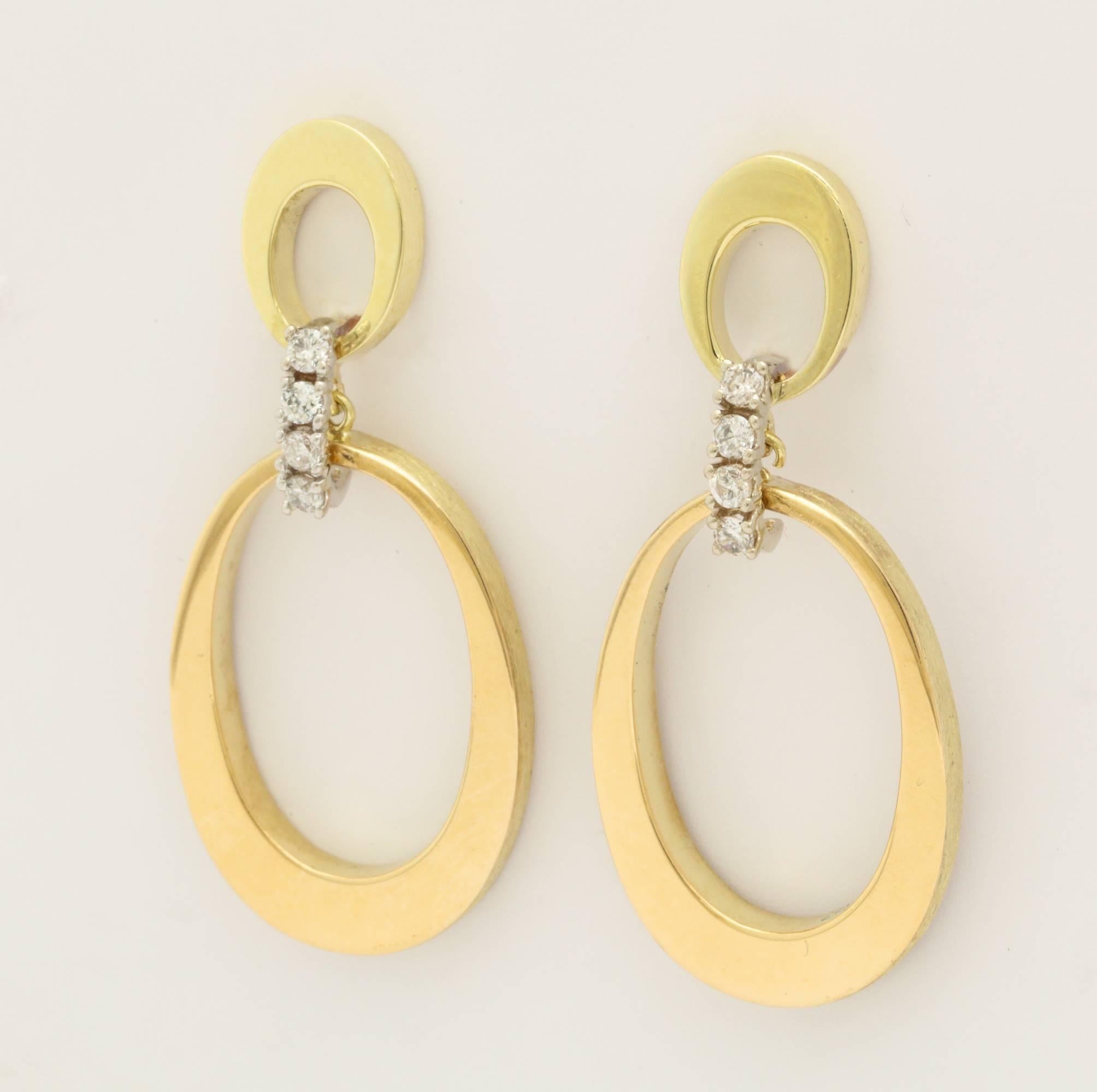 A stylish pair of 1960s modernist 14-karat gold earrings on diamond hinges.