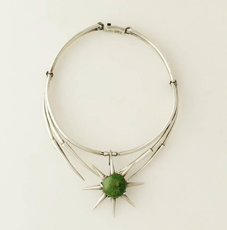 Being offered is an exceedingly rare circa 1960 sterling silver and jade necklace by Salvador Teran of Taxco, Mexico, of modernist design in a star burst motif, the center star measures 2 1/4 inches in diameter.  Measures 13-1/2" in total