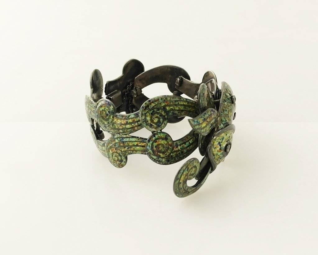 
Being offered is a circa 1963 sterling silver bracelet by Margot de Taxco of Mexico, featuring superb enamel work on this scarce piece depicting a koi fish with scroll seaweed like links

Probably the most iconic Margot De Taxco necklace in