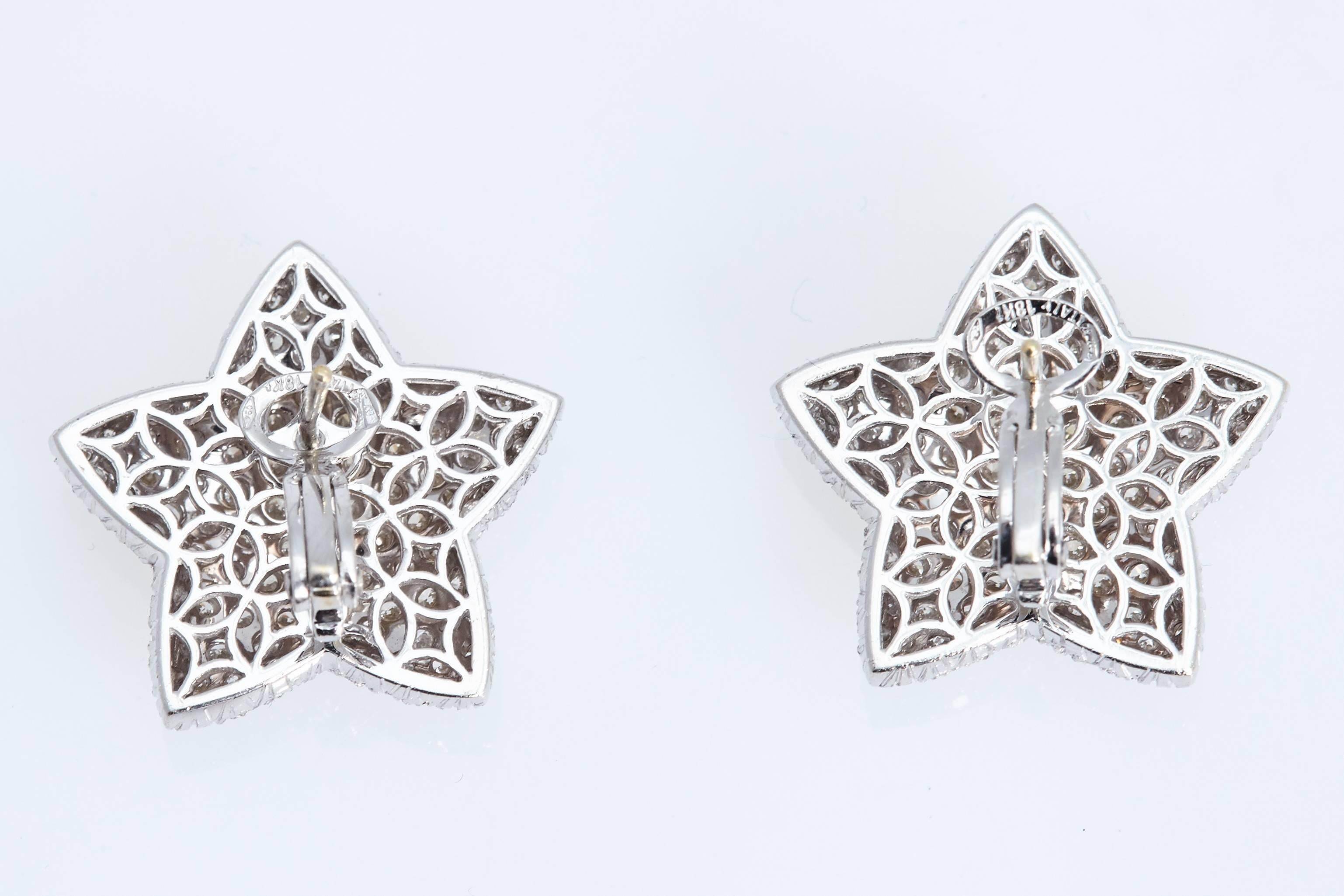 One pair of five point star earrings made up of 200 round diamonds with a total weight of approximately 4.80 carats.  The diamonds are "G/H" in color and "VS" in clarity. 
The earrings are 18 karat white gold and measure 1 inch