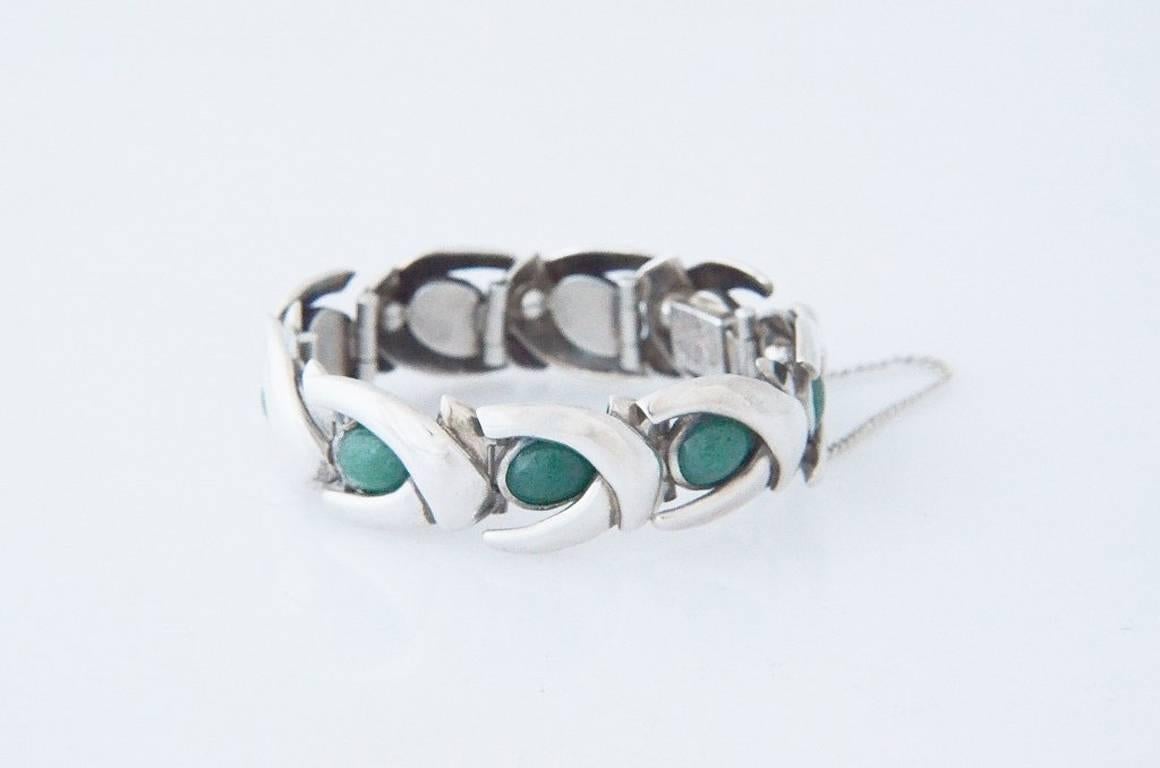 Being offered is a circa 1960 sterling .970 silver and jade bracelet by Antonio Pineda, of Taxco, Mexico, This masterful bracelet has 9 hinged stations each featuring a fine jade cabochon.   The bracelet has a wearable length (inner circumference of