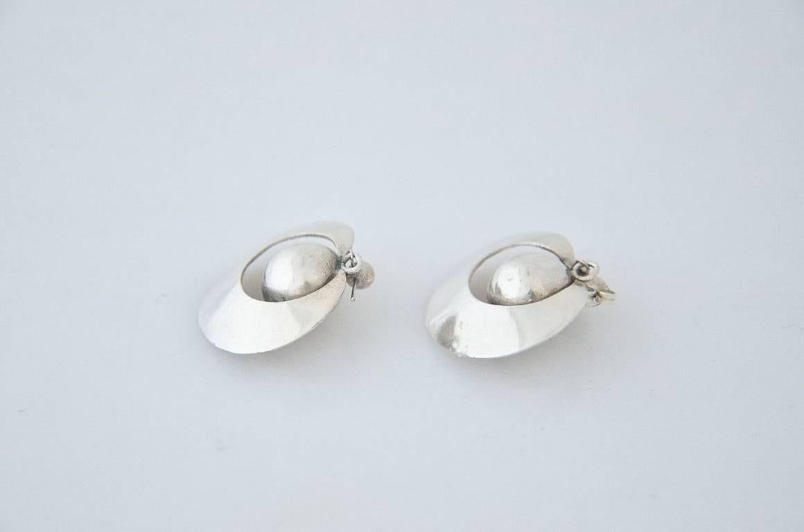 Being offered are a pair of circa 1950 sterling silver earrings by William Spratling, of Taxco, Mexico, with a 'ball' positioned in a circular cutout of silver.
They measure 1 inch x 1 1/4 inches.  Marked and in excellent condition