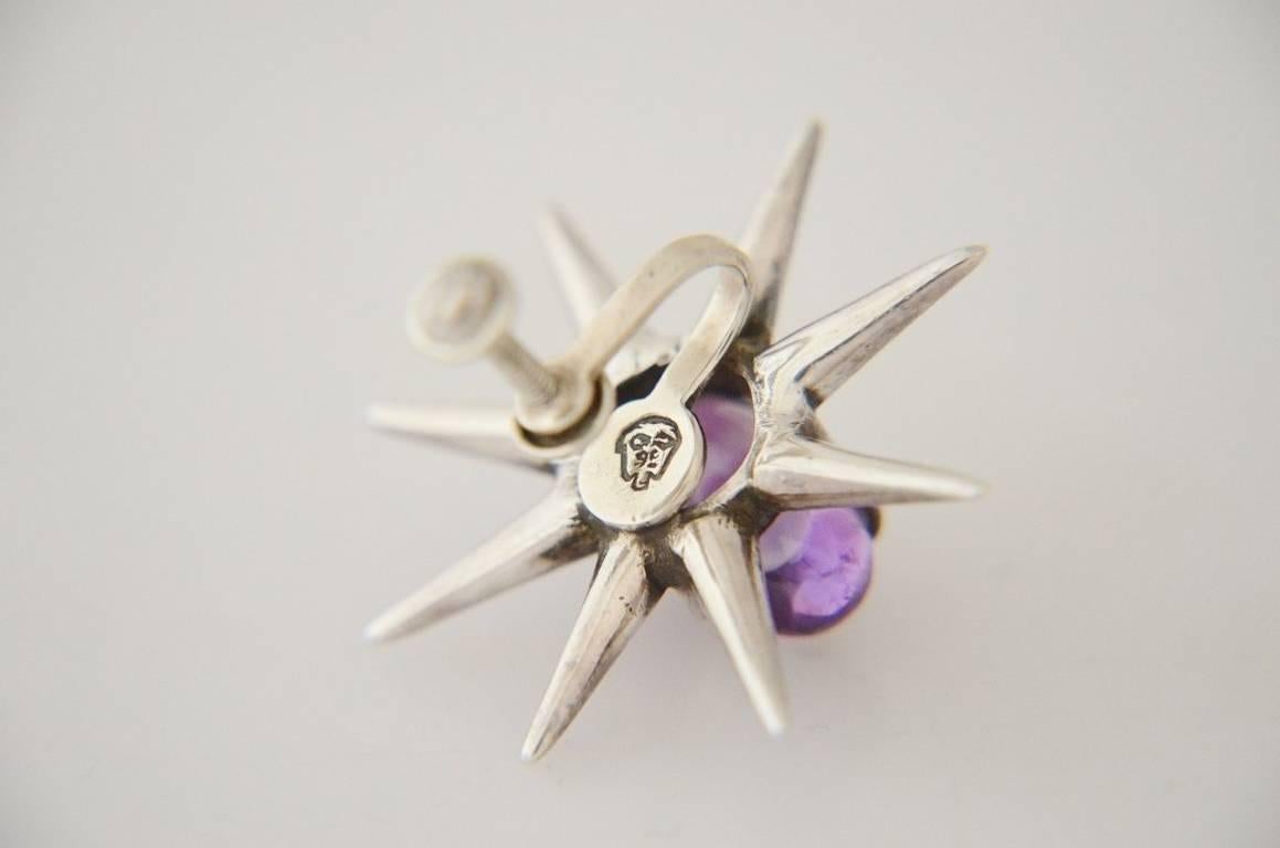 Being offered are a pair of sterling silver and amethyst earrings by Salvador Teran, of Taxco, Mexico, cabachon amethysts set in the rare Starburst motif.  Dimensions 1 1/2 inches diameter.  Marked.  In excellent condition.
