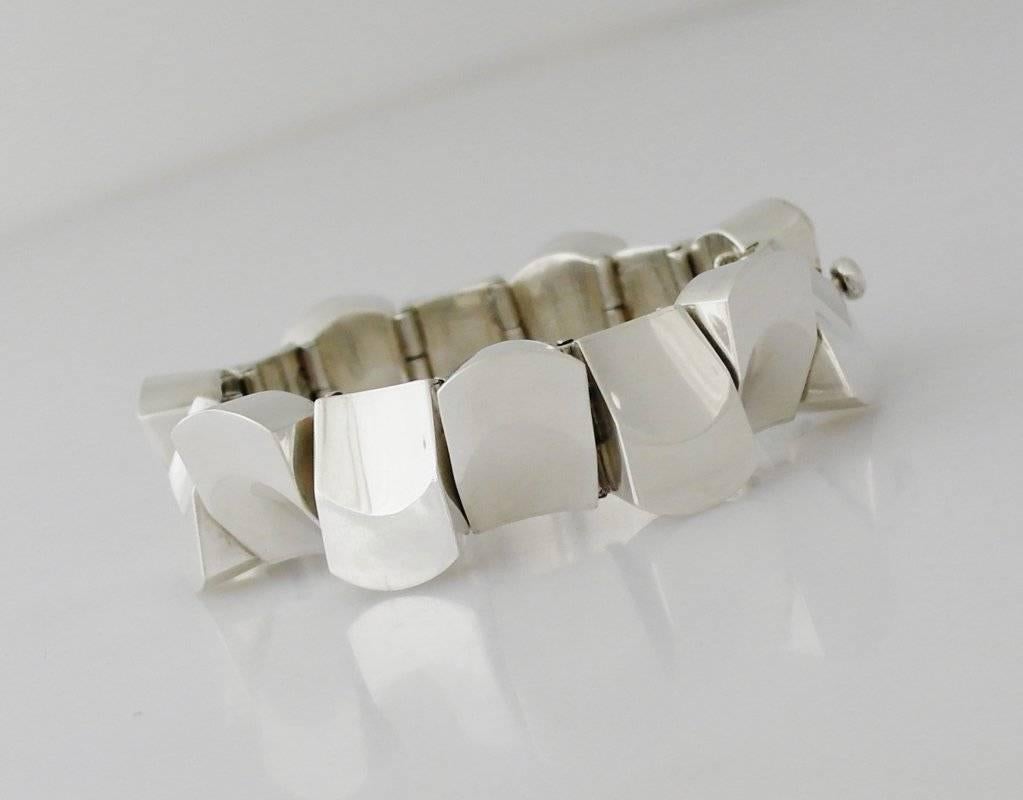 
Being offered is a circa 1960s bracelet by Antonio Pineda of Taxco, Mexico. Heavy gauge piece in the thumbnail design with each link placed in opposite directions; tongue & box closure with chain. Dimensions:  8 3/4" long x 7/8" wide;