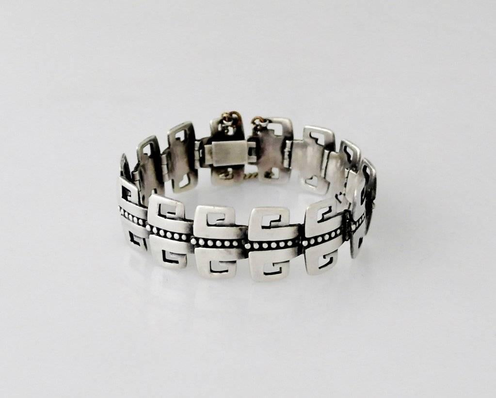 Being offered is a circa 1955 bracelet by Margot de Taxco, of Taxco, Mexico. Link bracelet with a double Greek key modernist design & beaded center; slide in closure & safety chain. Dimensions:. Bracelet is 8 1/8 long including the clasp, by