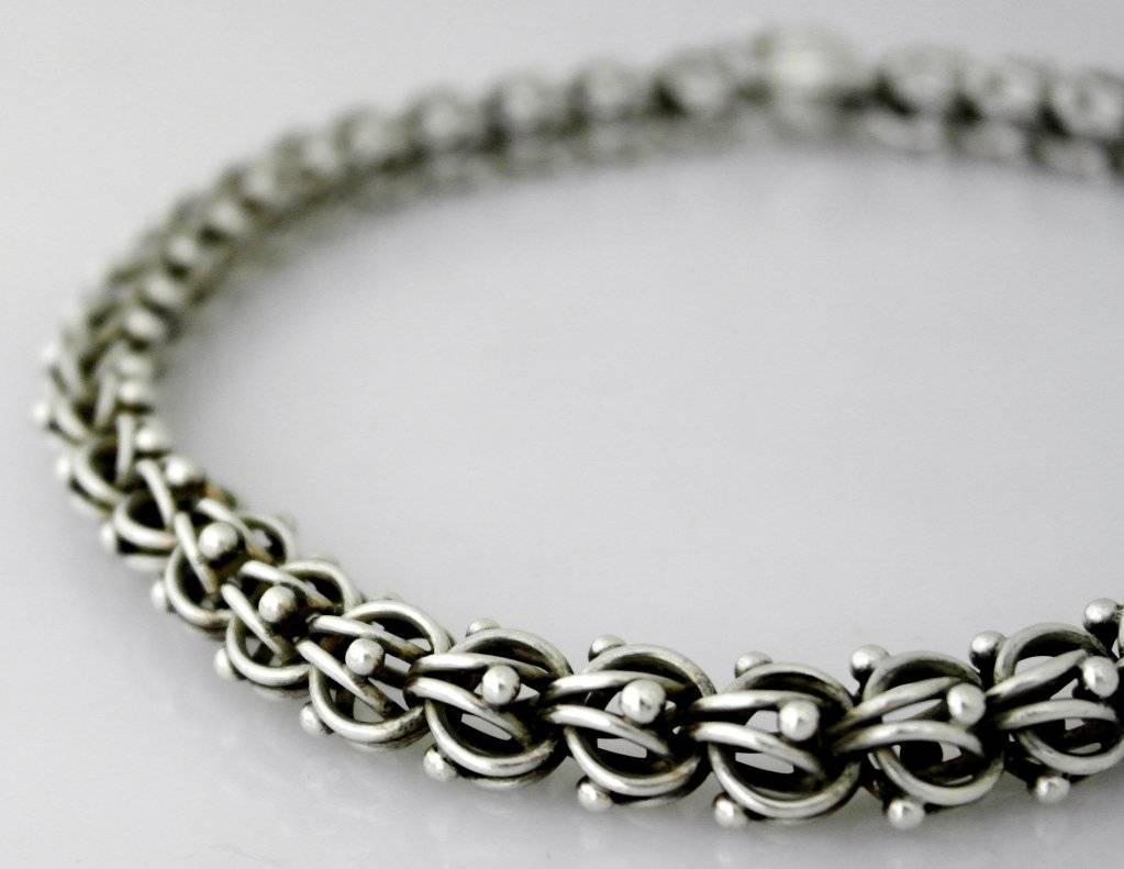 Being offered is a circa 1959 .970 silver bracelet by Antonio Pineda of Taxco, Mexico. of modernist design, the construction reminiscent of a DNA construction, the balls and swirled links constructing individual ball links. Length 16 1/2 inches.