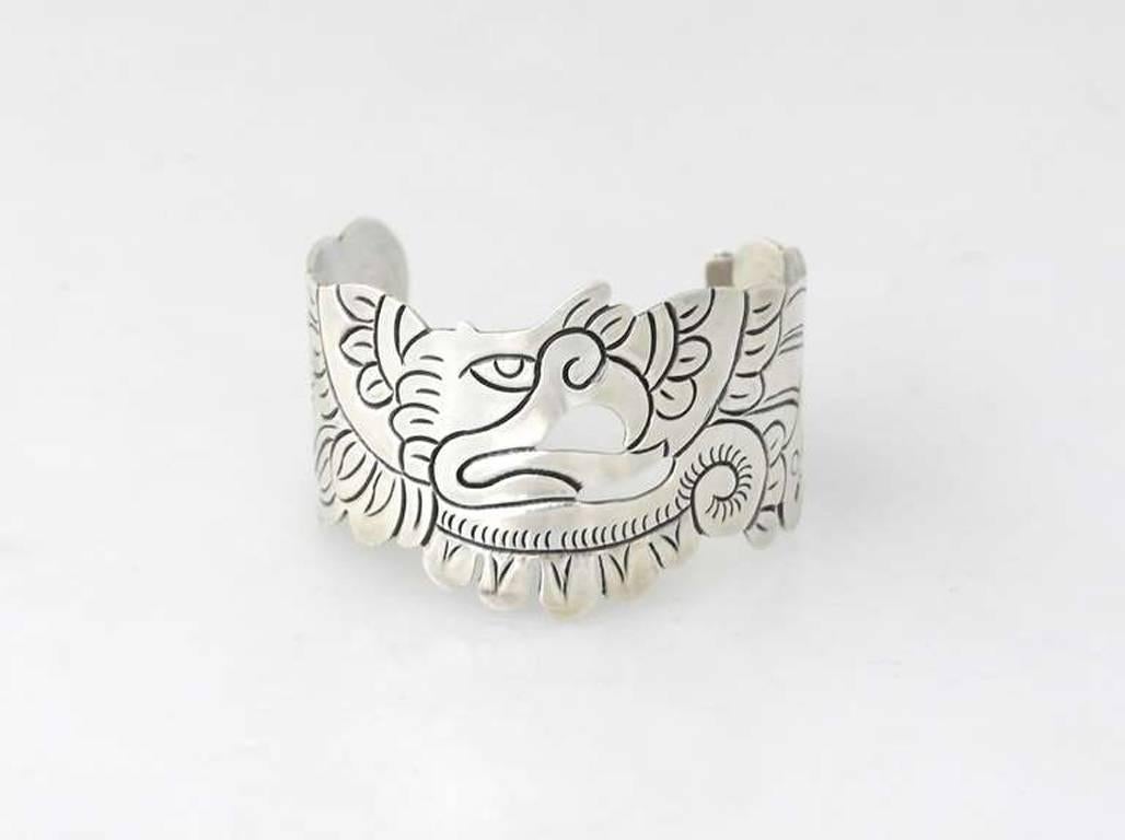 Being offered is a circa 1953 sterling silver cuff bracelet by Doris Silver Shop of Taxco, Mexico. Handmade pierced design with a chased eagle motif at the center. Dimensions: 6 1/2" length x 1 3/4" wide; opening is 1 3/4" (inner