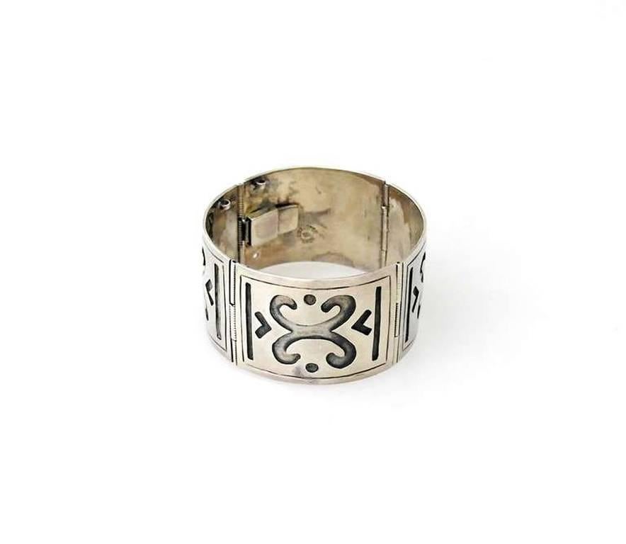 Being offered is a circa 1960 sterling silver bracelet by Bernice Goodspeed of Mexico; wide links with Aztec inspired motifs, secured by a tongue & box closure. Dimensions: 6 1 4" long x 1 1/4" wide; inside dimensions 6". Weight