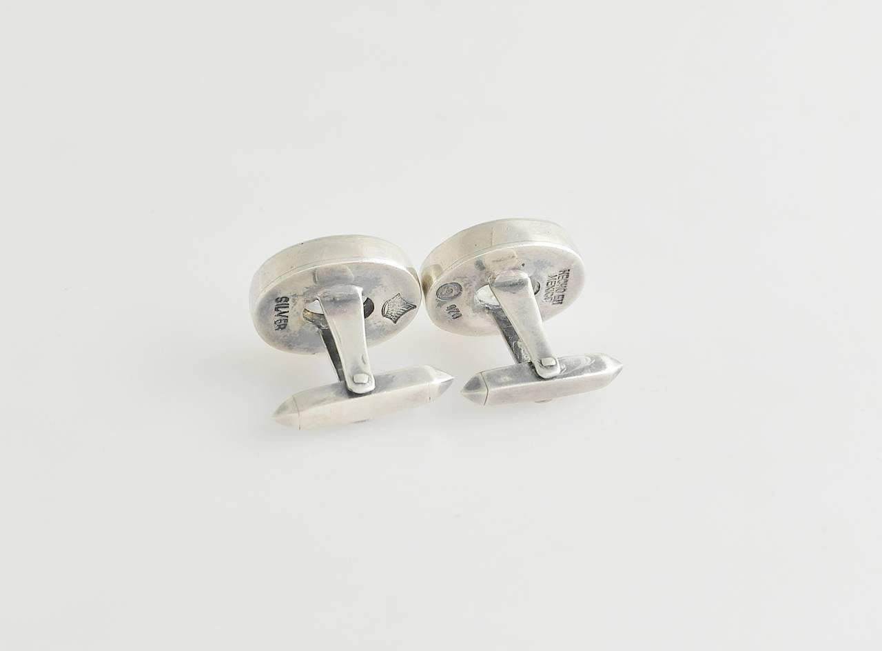 Being offered are a pair of circa 1960 .970 silver cufflinks by Antonio Pineda of Taxco, Mexico. the cabochon moonstones set in a modernist setting.  Dimensions 5/8 by 7/8 inches.  Marked.  In excellent condition.

Please visit Lauren Stanley to