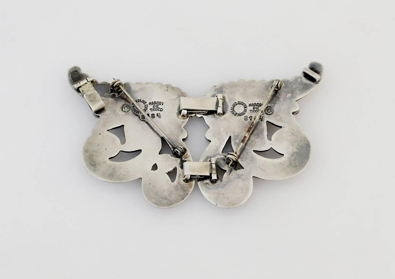 Being offered is a large sterling silver brooch by Margot de Taxco, of Mexico. Double hinged, two-sided large brooch, entirely handmade, with elegant scroll motifs. Dimensions: 3 7/8" x 2 1/4". Marked as illustrated. In excellent