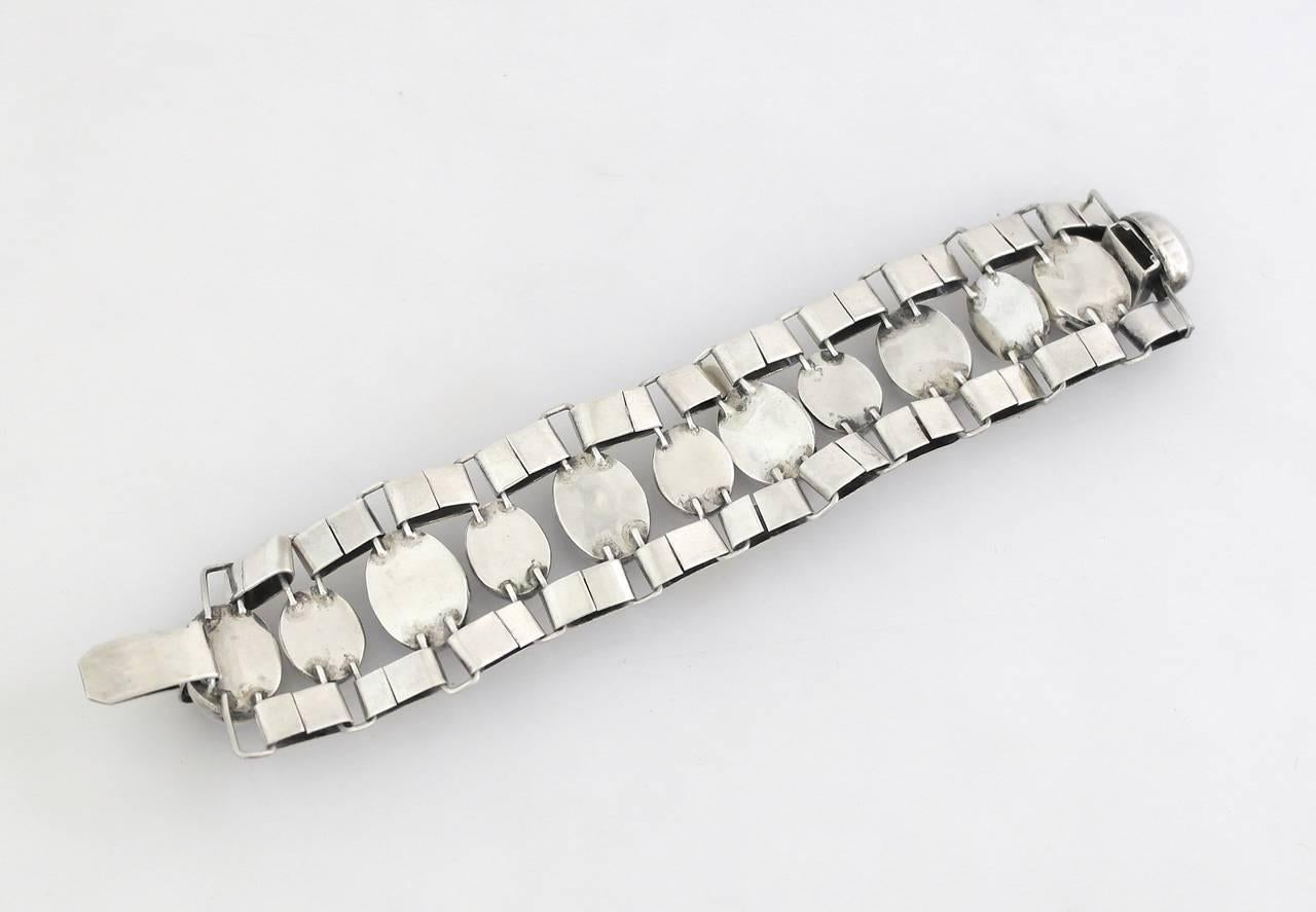 Being offered is a circa 1940s bracelet by Fred Davis of Taxco, Mexico. Early bracelet by one of the pioneers of the Taxco Silver movement. Adorned with oval shaped amethysts, attached to sterling silver links; tongue & box closure.  Length 7