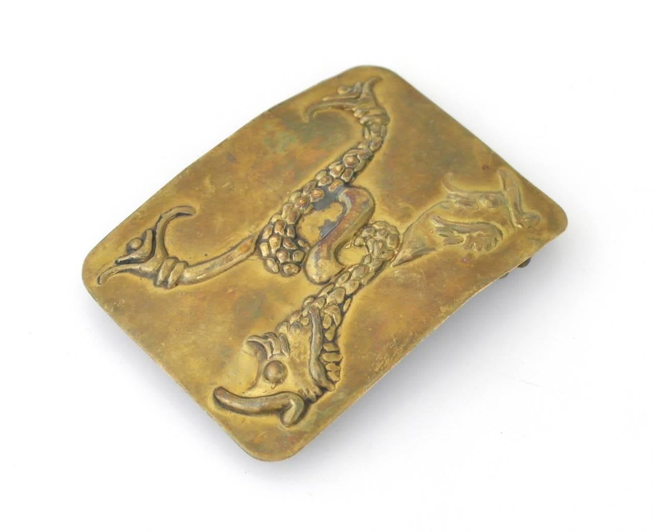 Offering a scarce brass belt buckle by Hubert Harmon of Taxco, Mexico. Made entirely of brass with embossed koi fish as the primary decorative element. Harmon only lived in Taxco a short while and was known for his whimsical design. His work is