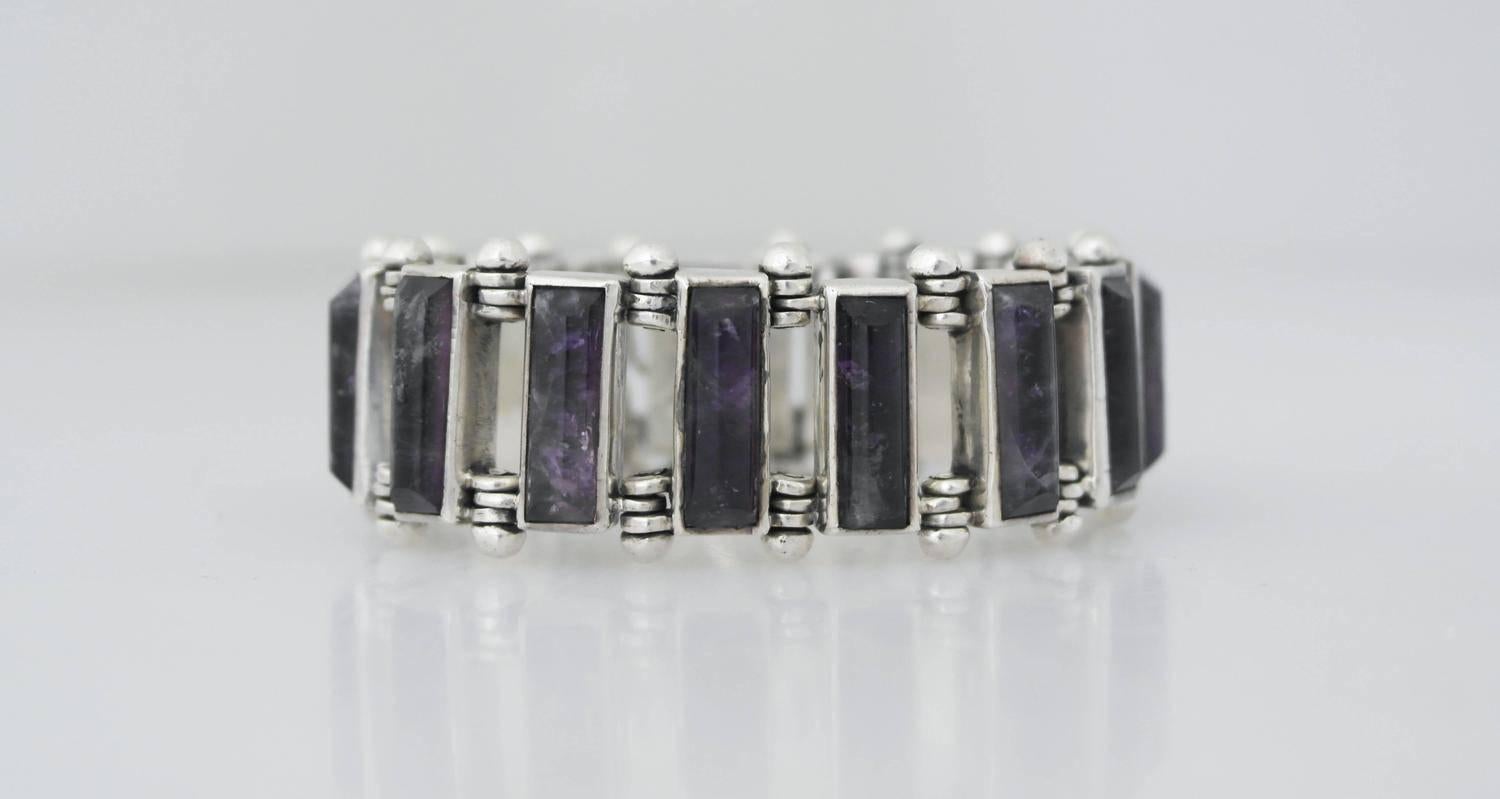 Being offered is a .970 silver (better than sterling) bracelet made by Antonio Pineda of Taxco, Mexico. Impressive bracelet made of heavy gauge silver, decorated with rectangular shaped domed amethyst links. Tongue & box closure with security