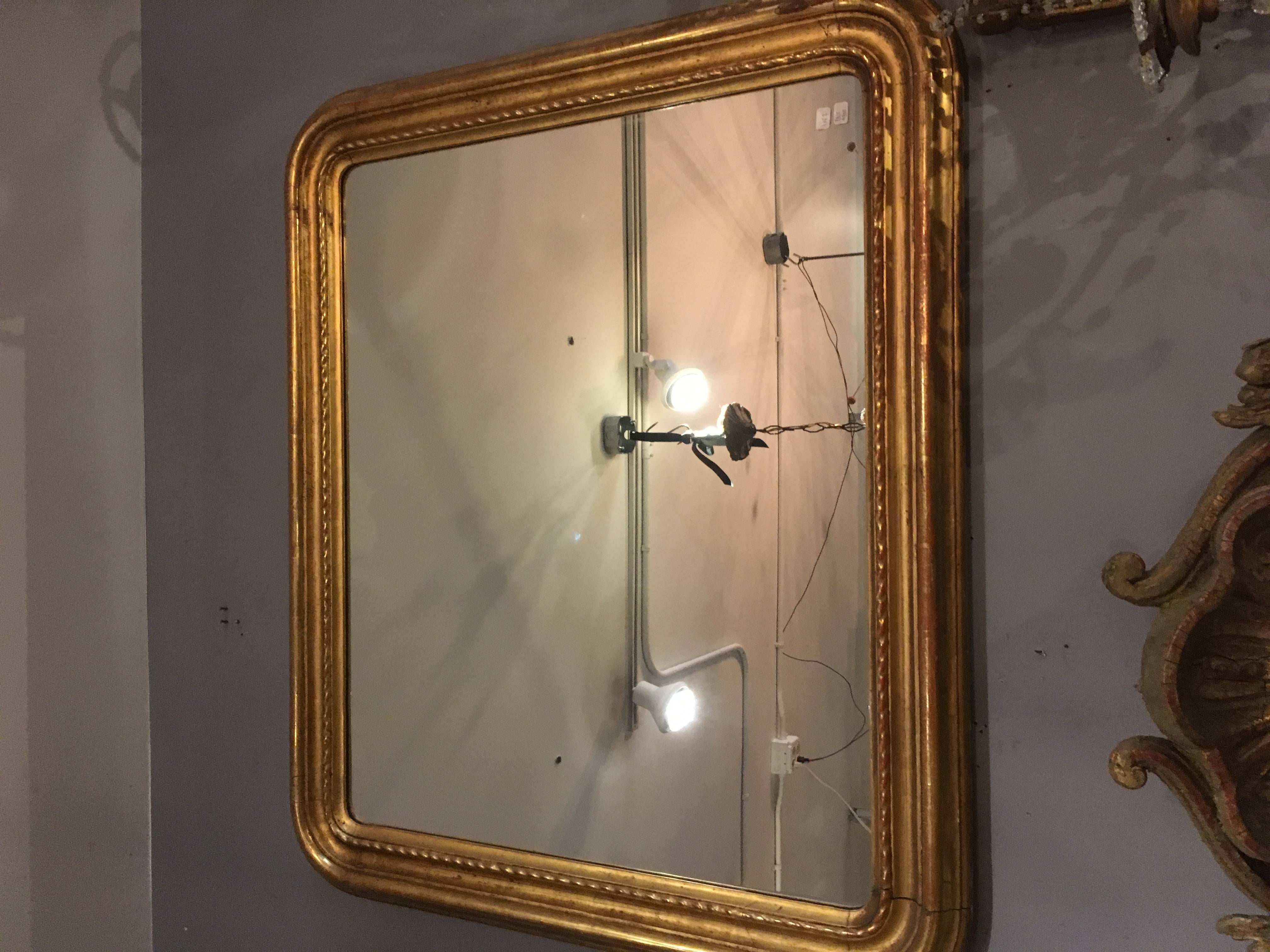 Beautiful rounded corner rectangular pair of mirrors that can be hung tall or wide. Lovely patina on the gilded frames and good mirror surface. Perfect powder room mirrors or used anywhere.