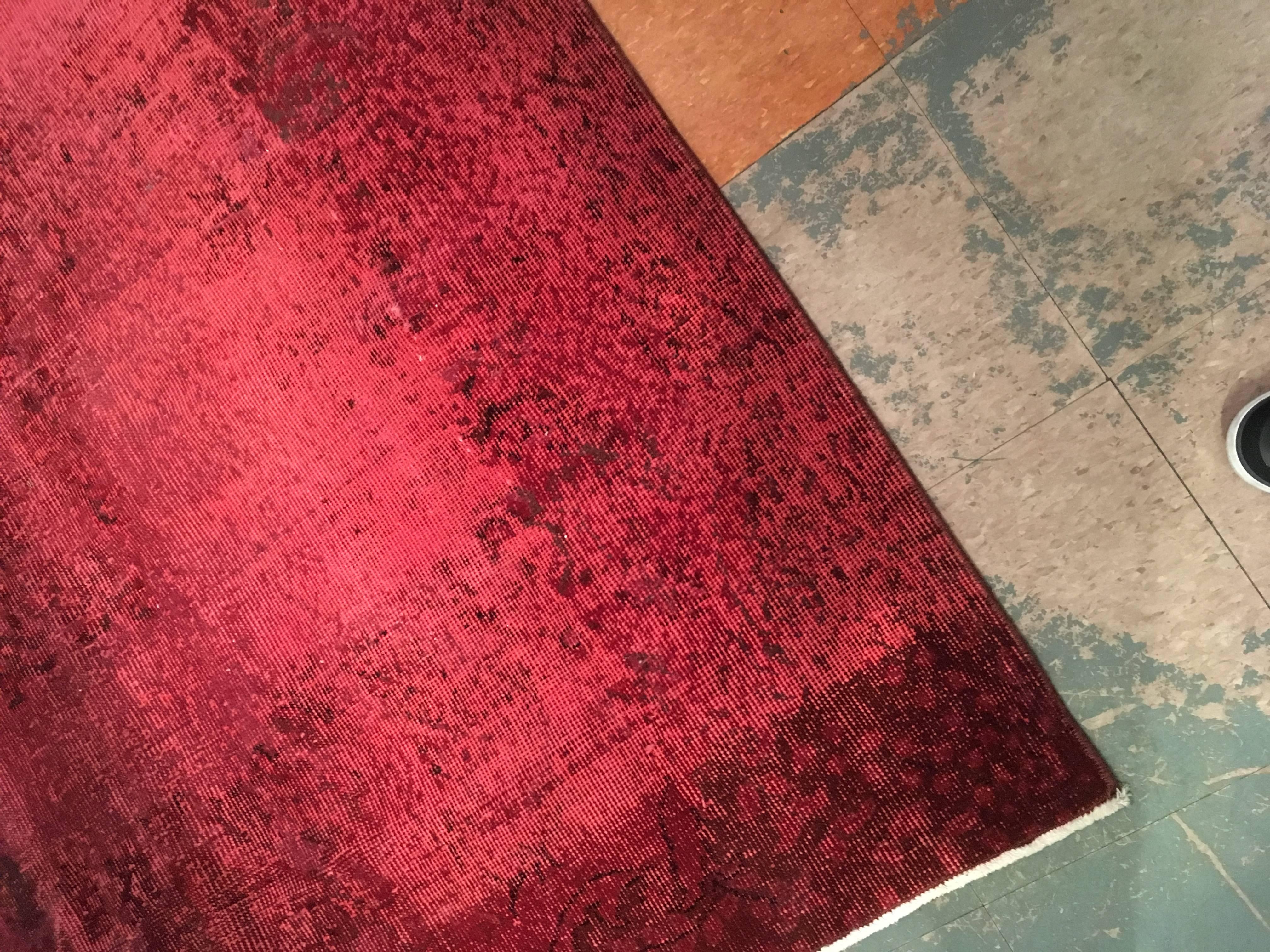 Vintage carpet overdyed in red with hints of black. Durable, great pop of color in any room.