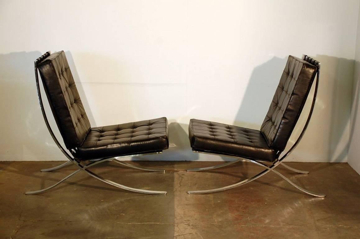 Pair of oversized French 1970s Barcelona style chairs. Not the typical Mies van der Rohe copy; a reinterpretation of the design from the 1970s. Purchased in Paris at Artcurial auction house. Measures: Seat slopes down from 18 to 14 in height.