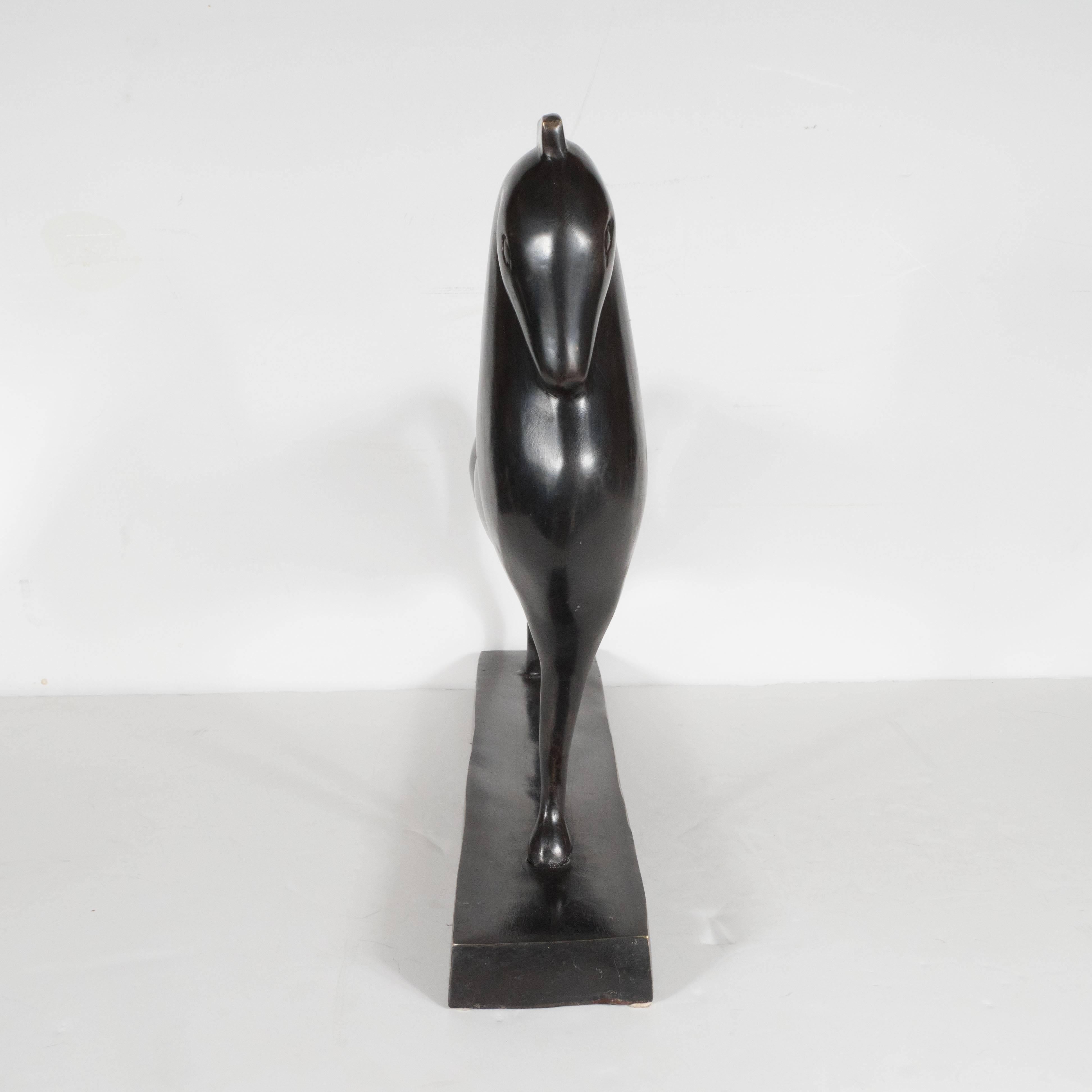 This sleek Mid-Century Modernist sculpture recalls the Classic Etruscan horse- a motif popular in Greek art between the 9th and 2nd centuries B.C. From the side, the sculpture appears to be a robust horse in profile leaning forward, with its head