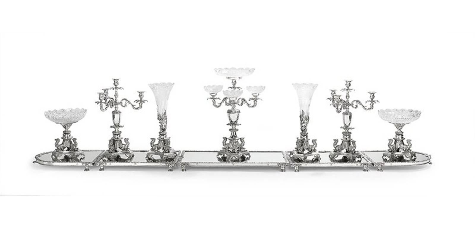 12-piece Egyptian Revival silver plate and cut-glass Surtout de table service

In the Victorian manner, for the orientalist market, marks for Sheffield.

Comprised of a three-arm epergne ht. 20 1/2, 
a pair three-light candelabra ht. 19, 
pair