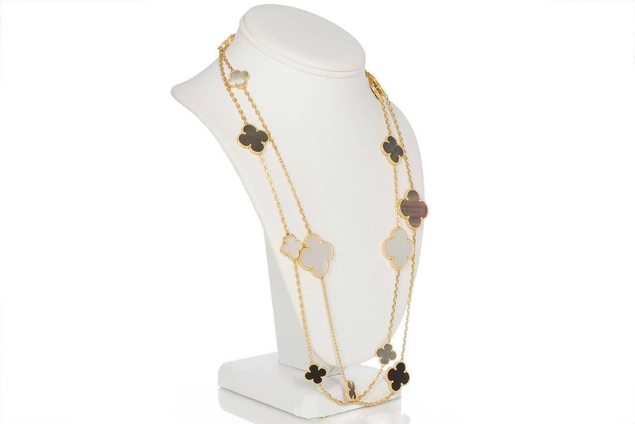 We are pleased to offer these beautiful Guaranteed Authentic Van Cleef & Arpels 18k Yellow Gold Magic Alhambra 16 Motif Necklace. This stunning necklace is 48" long features White Mother-of-Pearl, Gray Mother-of-Pearl and Onyx motifs all
