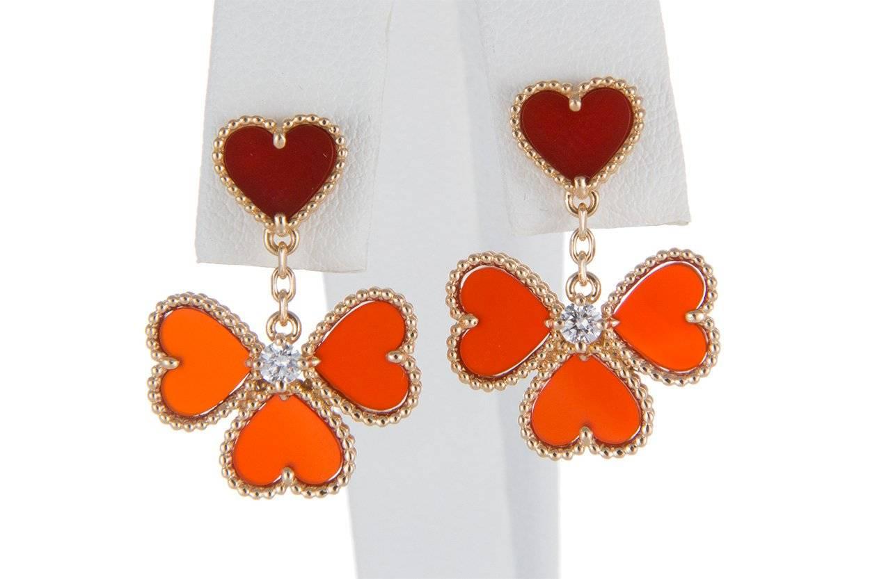 We are  pleased to offer these beautiful Guaranteed Authentic Van Cleef Arpels 18k Rose Gold Diamond & Carnelian Sweet Alhambra Effeuillage earrings. These stunning earrings feature heart shaped carnelian and 0.17ctw round brilliant cut diamonds