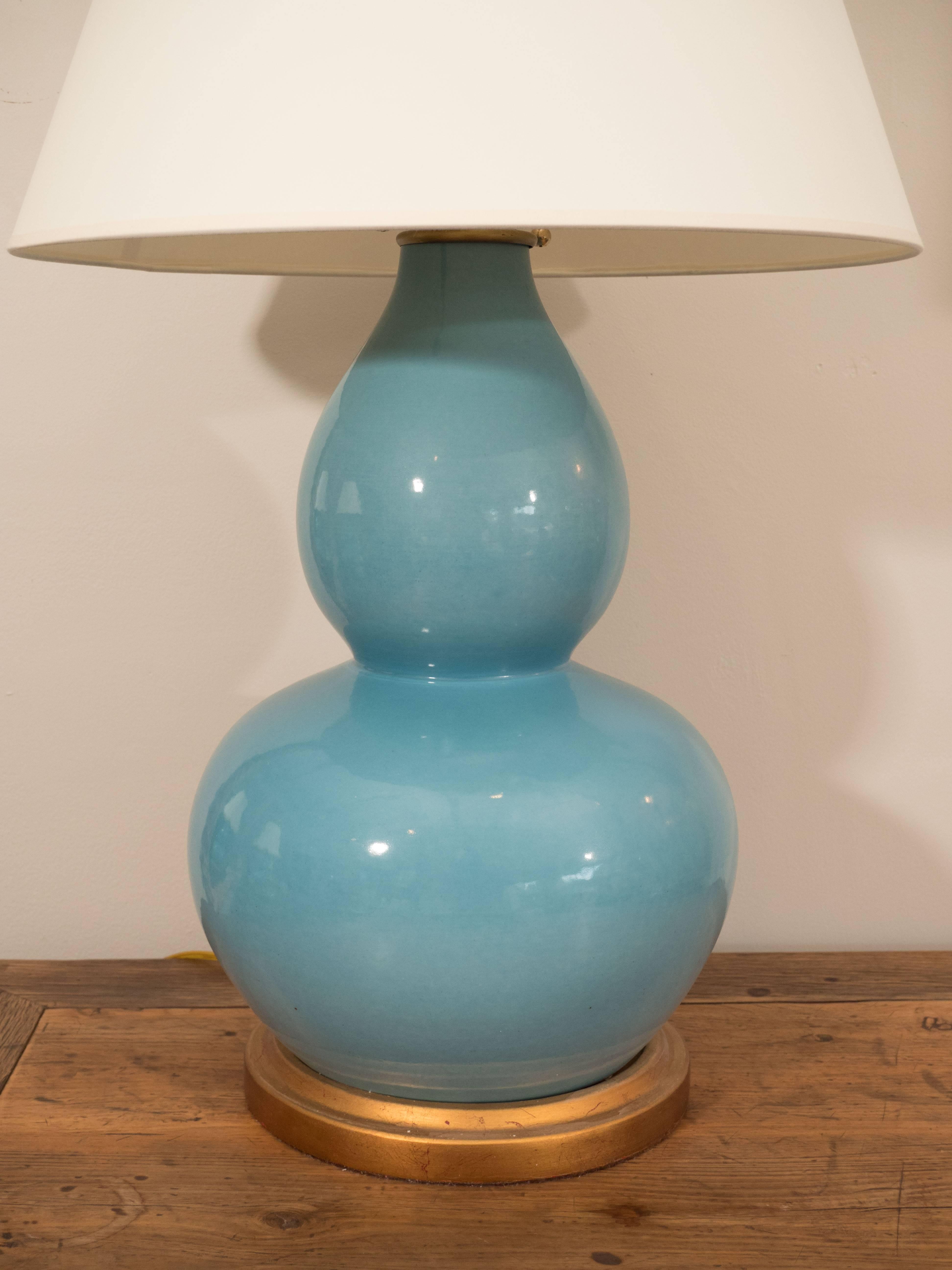 The mineral lamp by Bunny Williams Home. This pair of double gourd ceramic lamps on a gilt base are well made, versatile and cheerful. Their lovely shade of blue can work with neutrals, greens, creams, whites, browns. The perfect finishing touch in