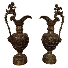 A Pair of Antique French Patinated Bronze Ewers with Bacchanalian Scenes