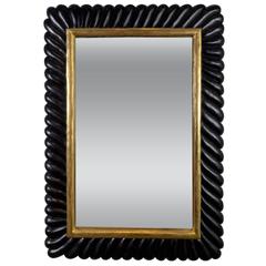 Ebonized Carved Mirror with Gilt Highlights