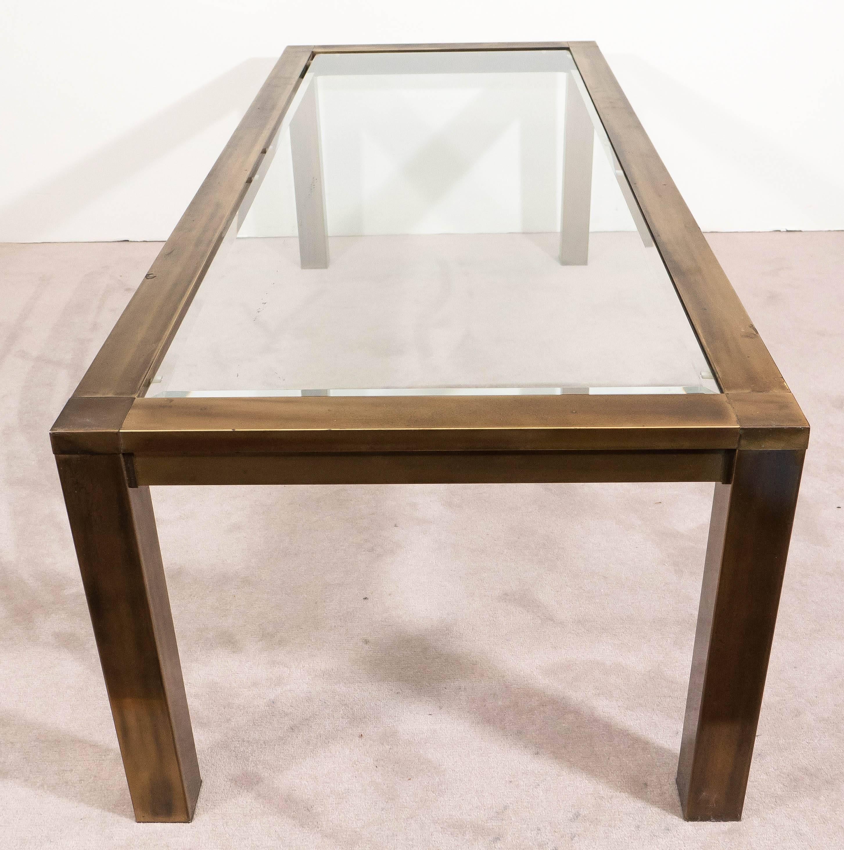 A vintage coffee or cocktail table, produced, circa 1970s by Mastercraft, with brass frame, inset with glass top, on rectangular legs. Good condition, with age appropriate wear, nice patina to the brass surface. 9001.