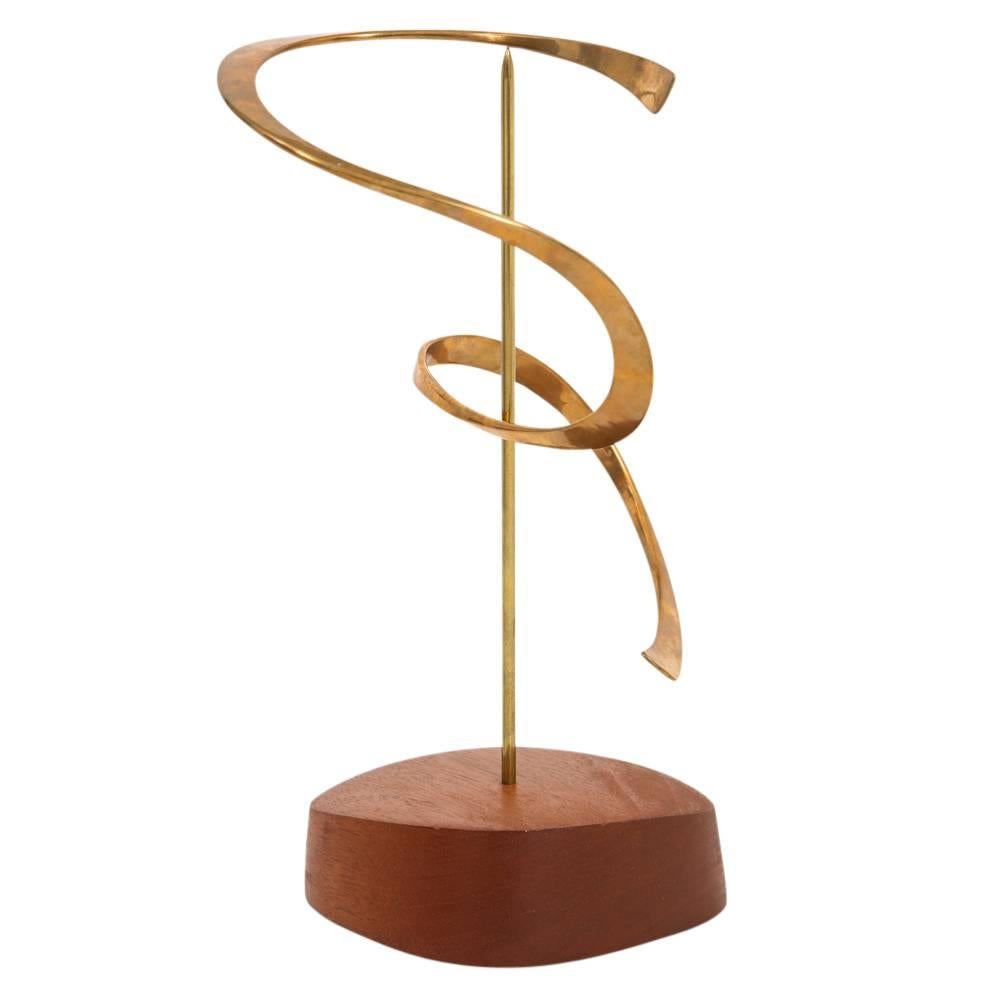 Russell Secrest, bronze, sculpture, kinetic, signed. Table top kinetic sculpture which balances and rotates on a steel rod, with a pointed tip, which is sunk into rounded triangular walnut base. Stamped: Bronze Secrest.
I spoke with the late