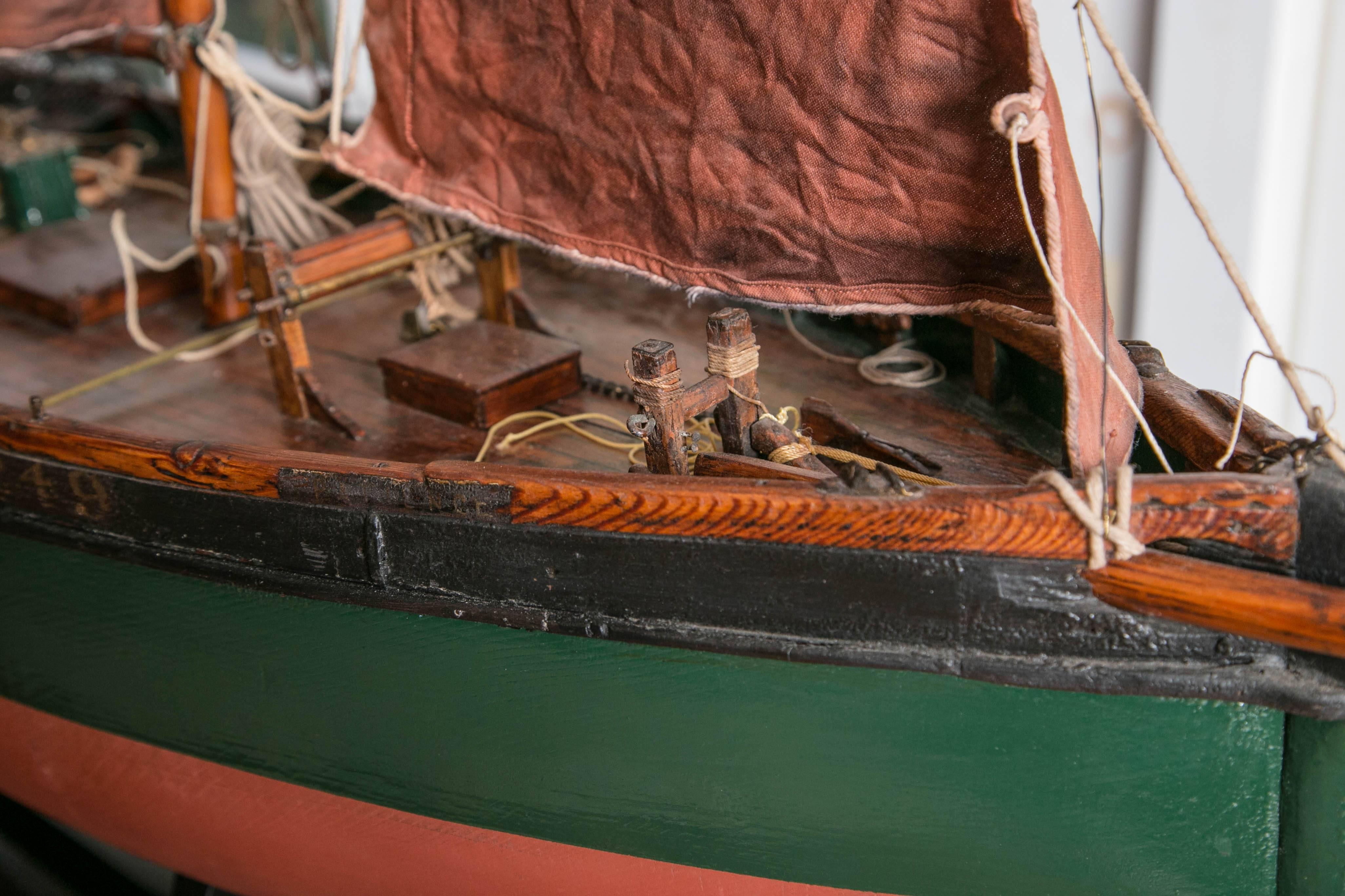 Fully fitted with proper sails (colored the tint that they would have been after their first proofing coat), chains and anchor, it proudly displays its workman roots. Employed through much of the 19th century along the coasts, these boats even found