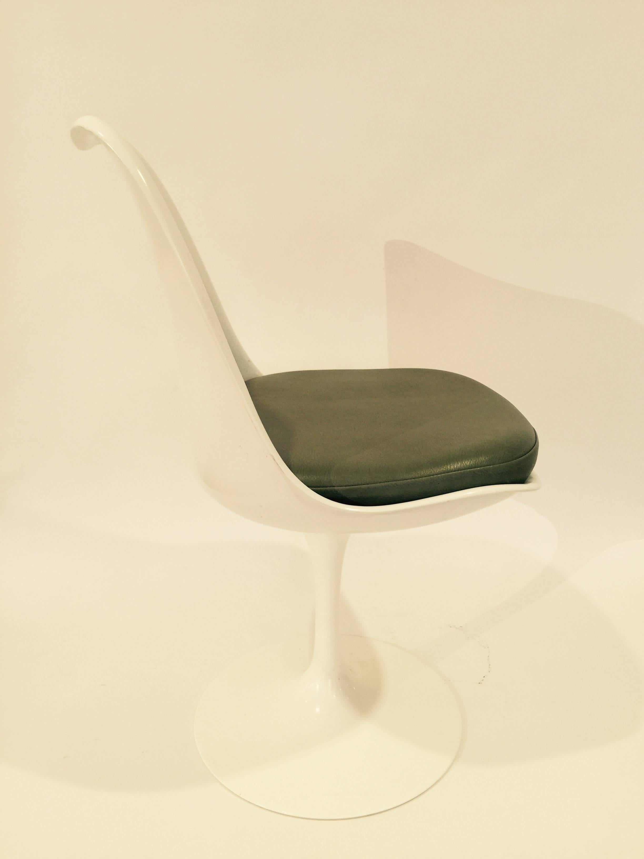 White tulip dining chairs by Saarinen for Knoll Studio, USA, circa 2005 production. Features white semi-gloss finish with olive green leather cushions. Signed. Priced individually; six available. 

Also available for rental with pick up from our