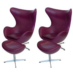 Vintage Pair of Original Egg Chairs with Ottomans by Arne Jacobsen in Mulberry Leather
