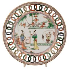 A Chinese porcelain famille verte dish with openwork cash border, 17th century