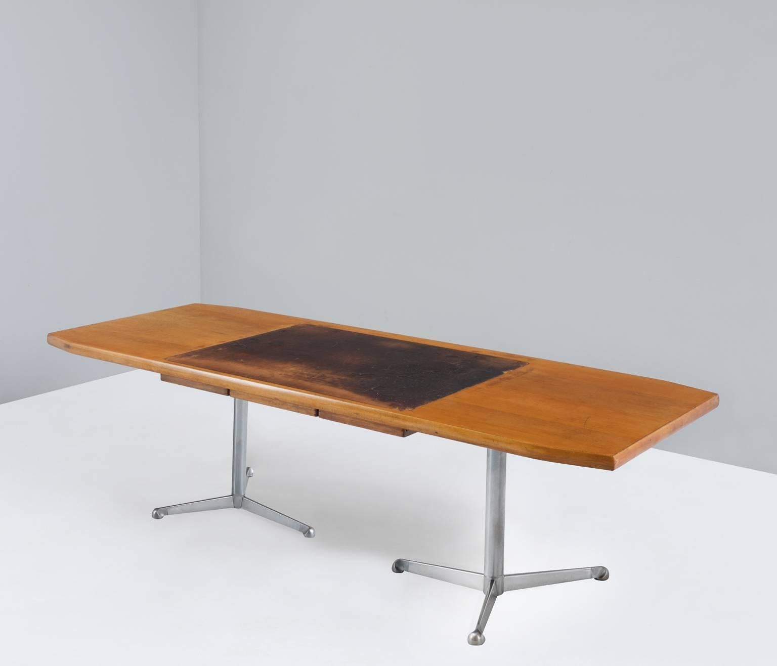 Beautiful Osvaldo Borsani writing desk with a gorgeous patinated leather writing area.

This table is equipped with two chromed tubular steel tripod feet which is a great contrast with the walnut top. The heavy tabletop conceals leather writing