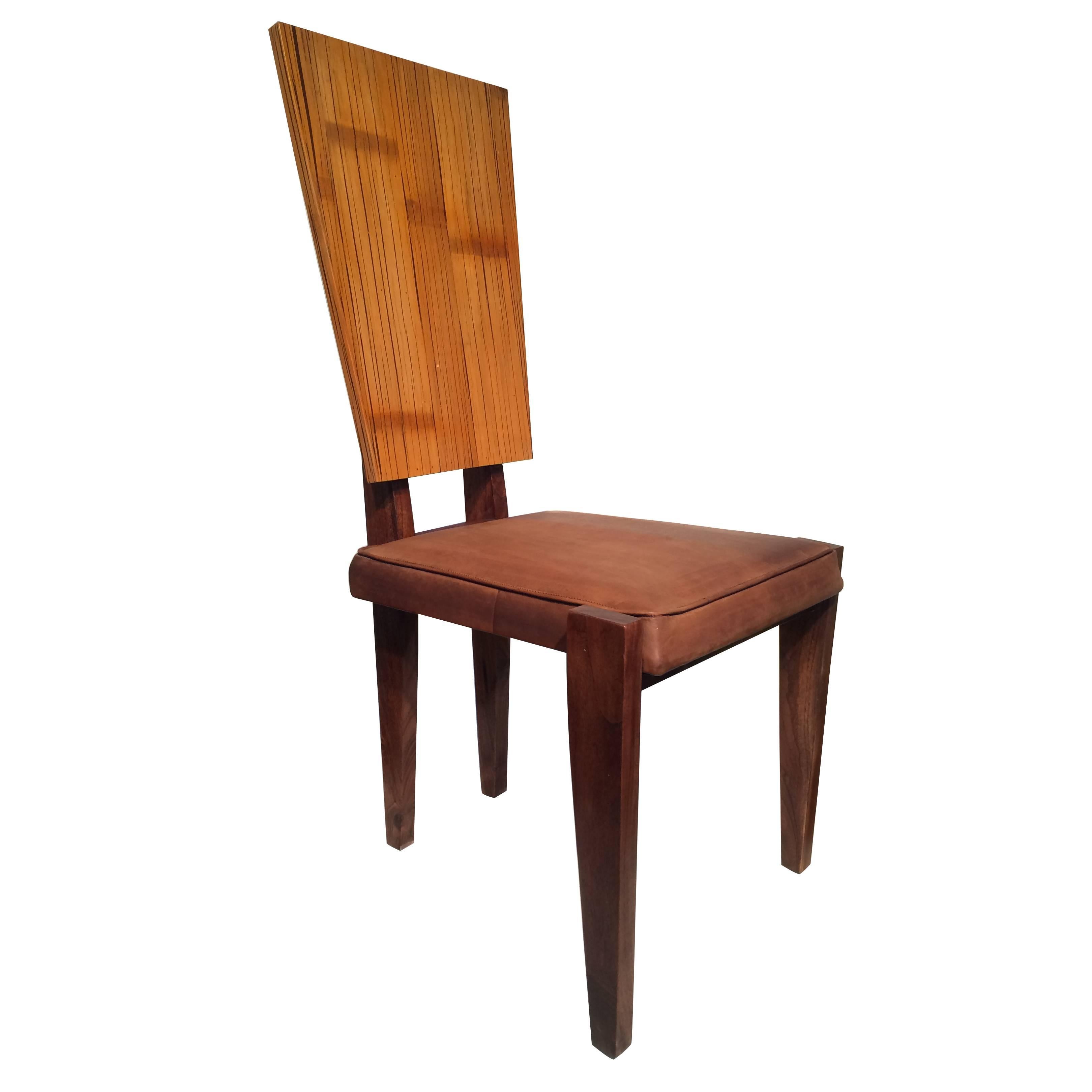 A chair by Andre Sornay. bamboo veneered back with walnut frame and leather upholstery, France, 1940.
